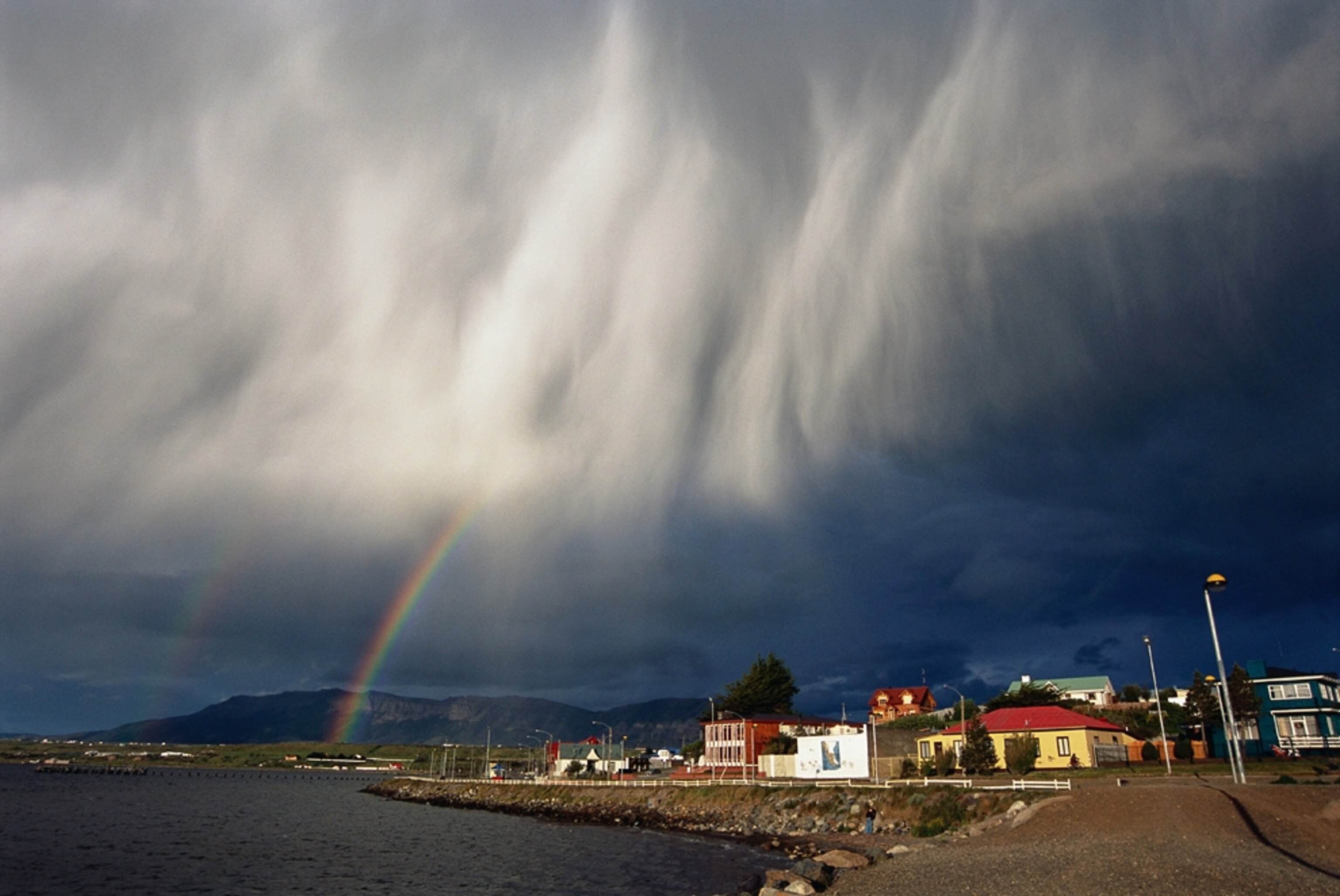 a double rainbow over a Chilean coastal town