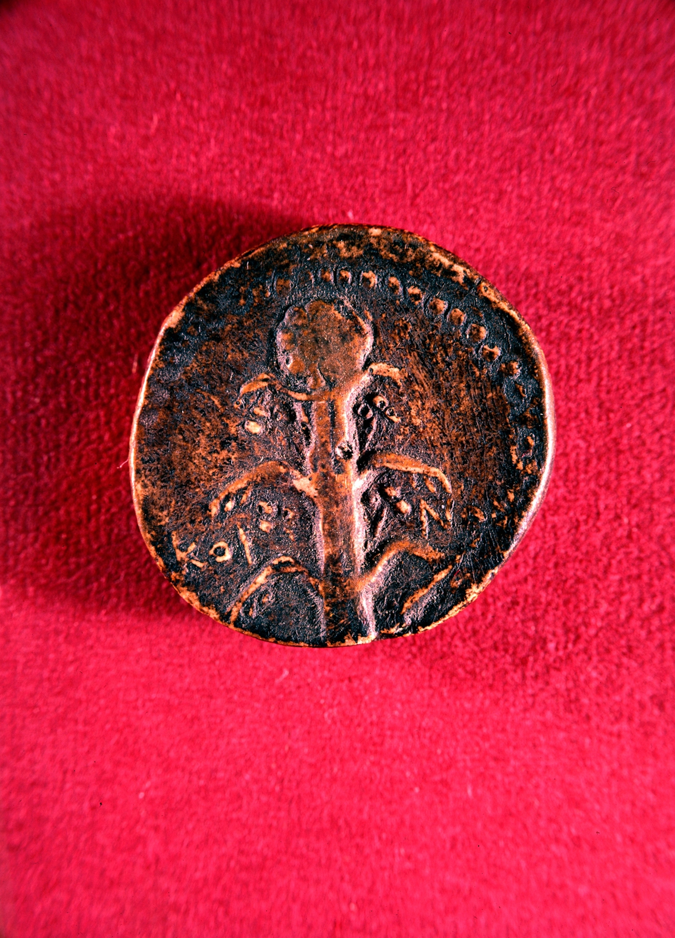 a Green coin with silphium on it