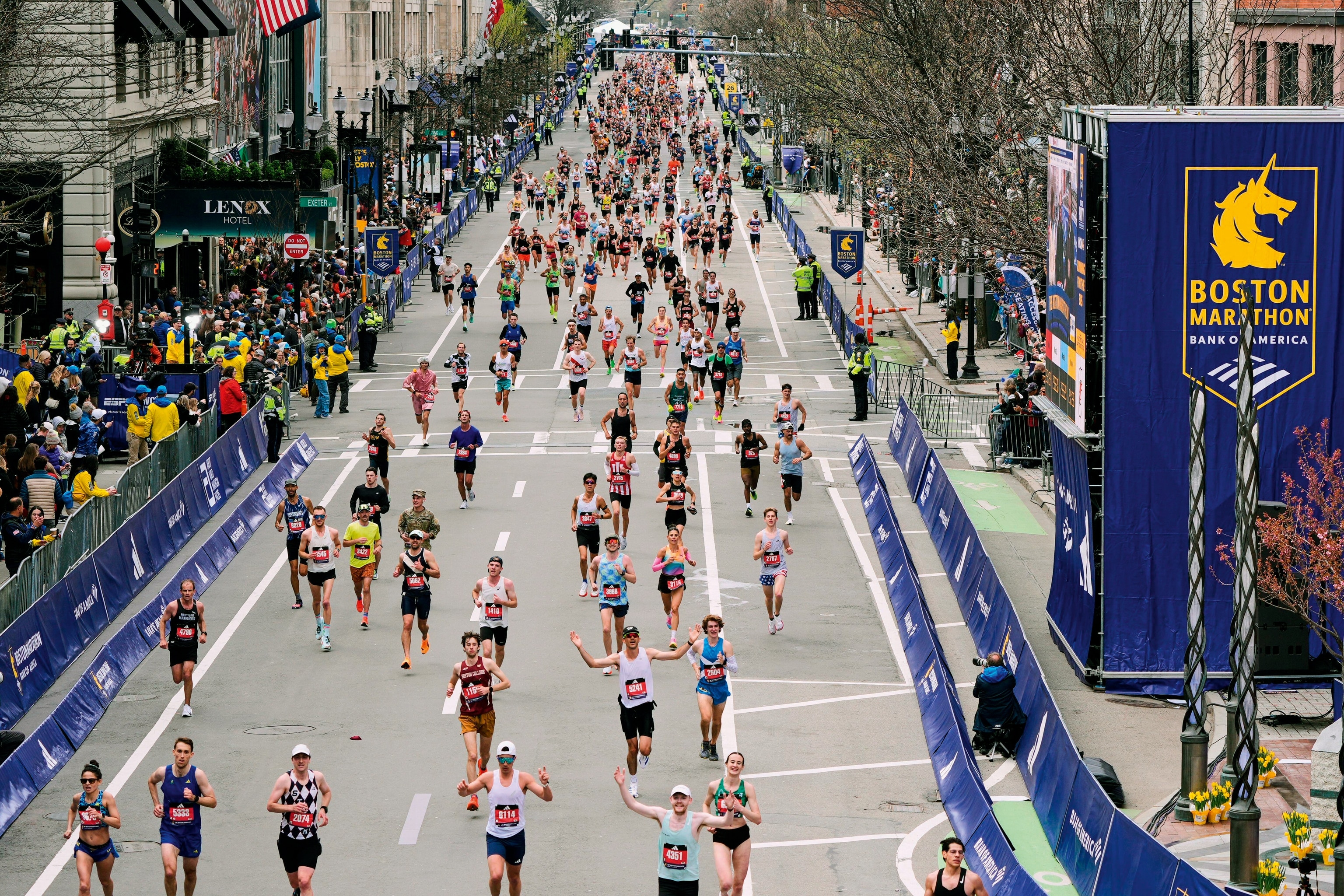 People run down a street for the marathon