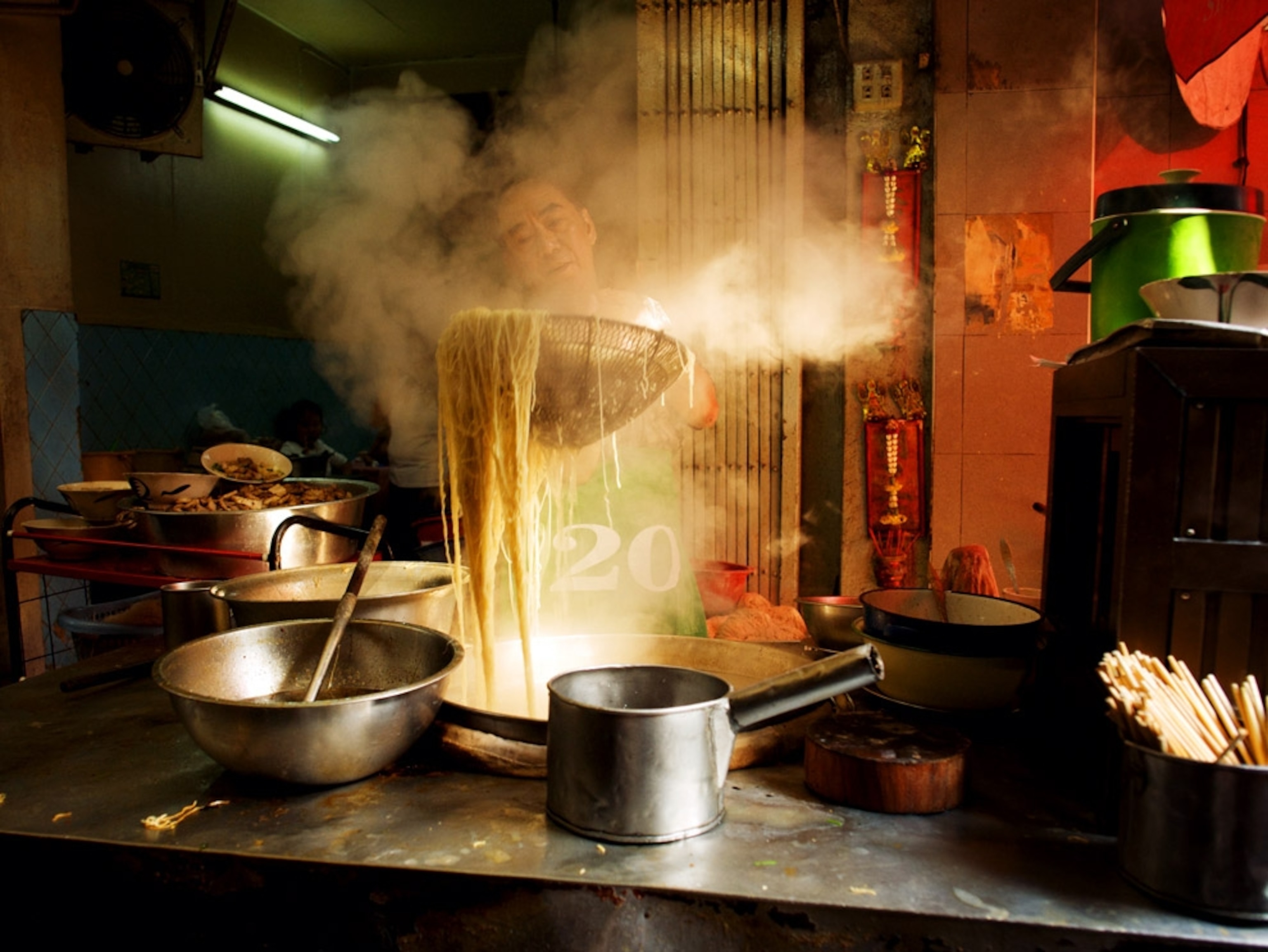 Man preparing noodles on a Bangkok street