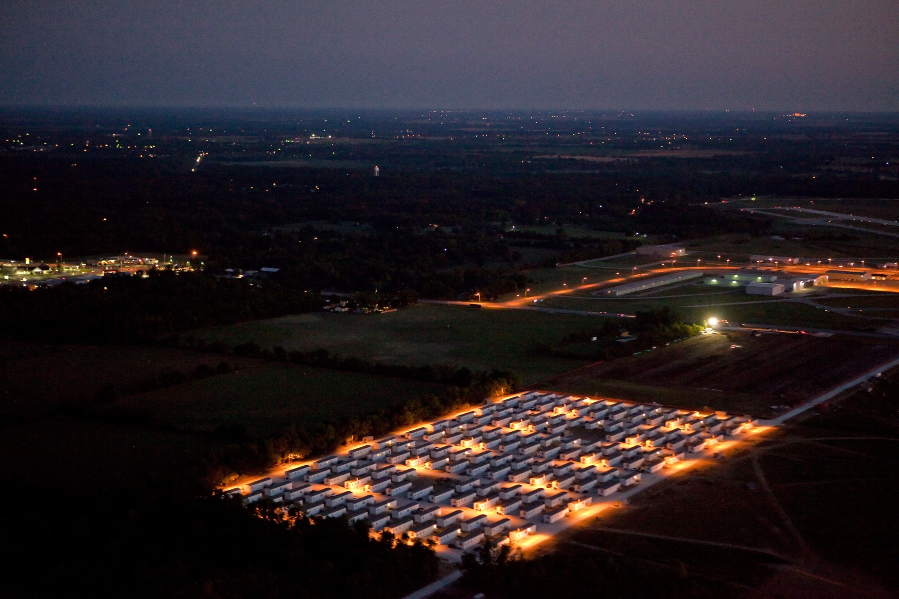 How Joplin Recovered - Porch lights of a FEMA trailer park at dusk in Joplin, Missouri.