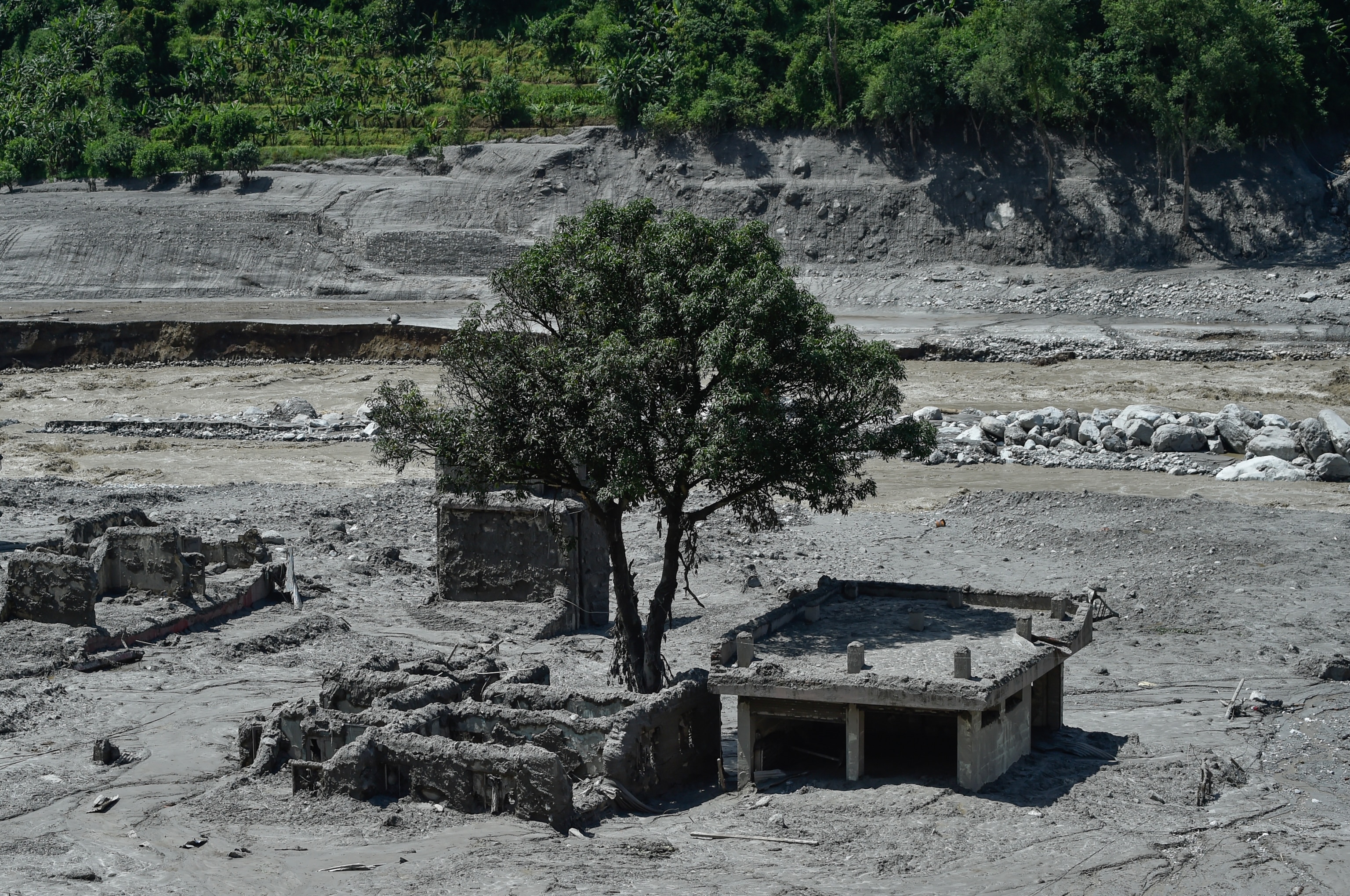 Remnants of a house and structures covered in mud from the mudslide in Nepal.