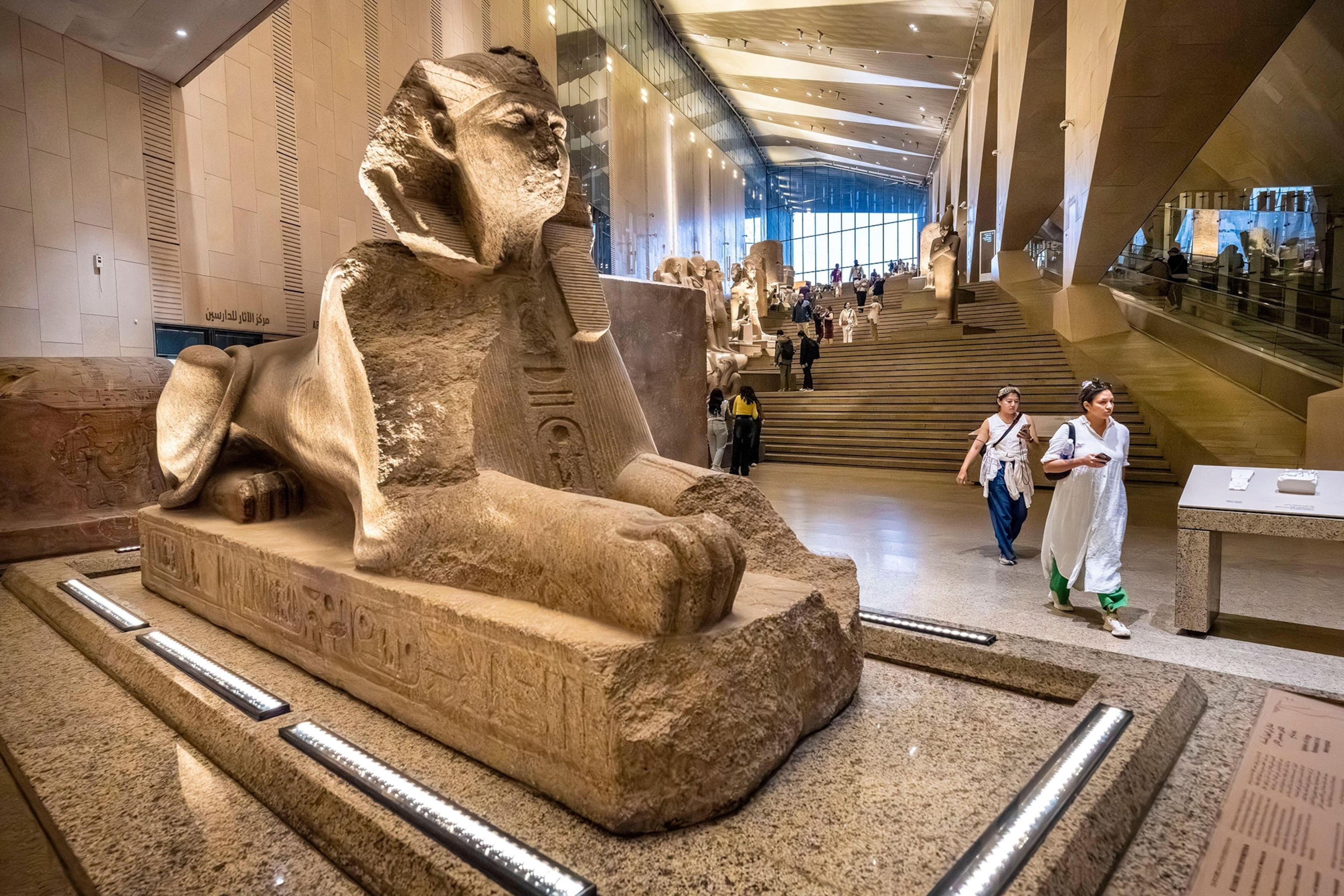 A small sphinx statue in the entrance hall of a museum.