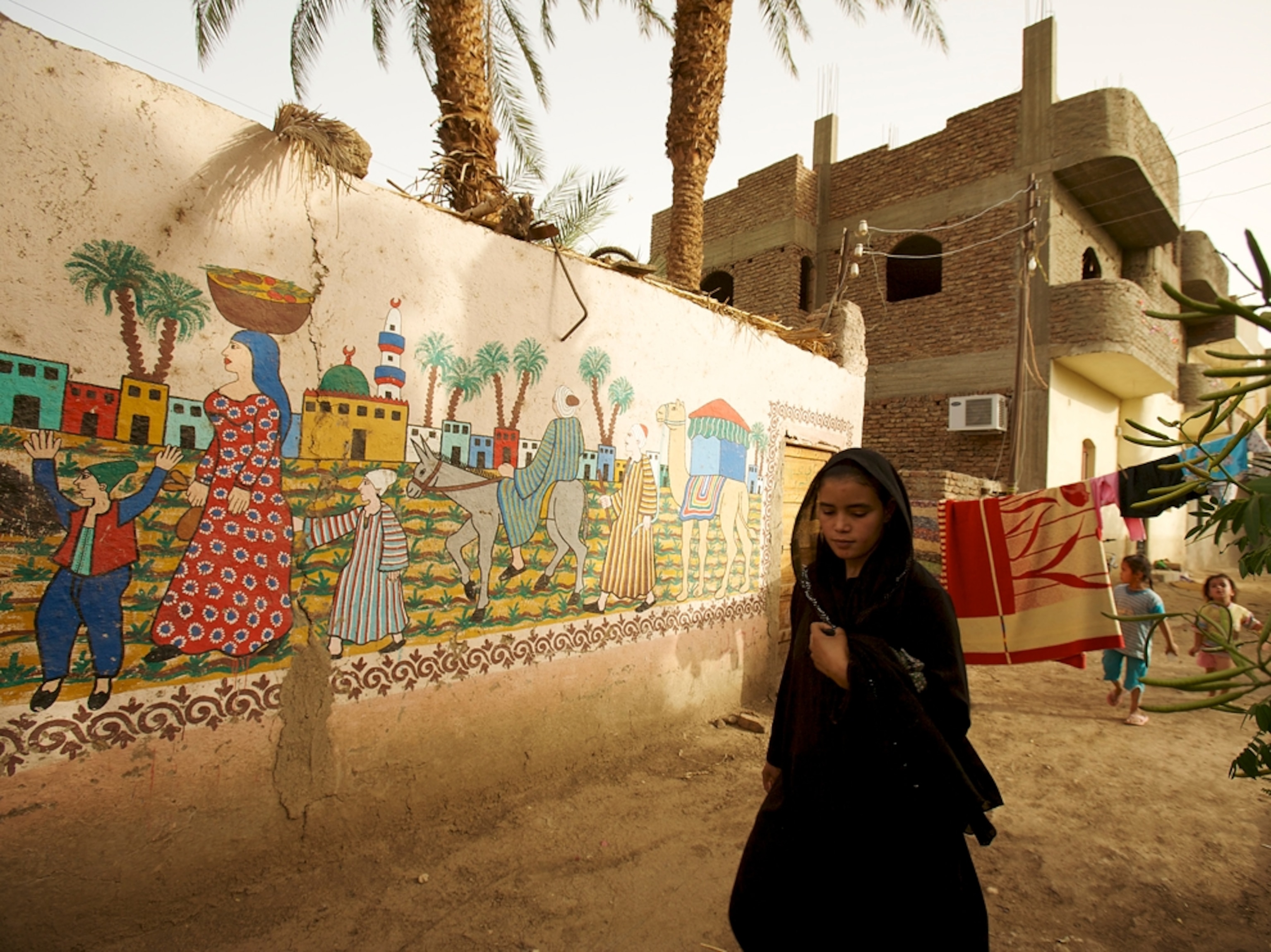 Girl walking by murals