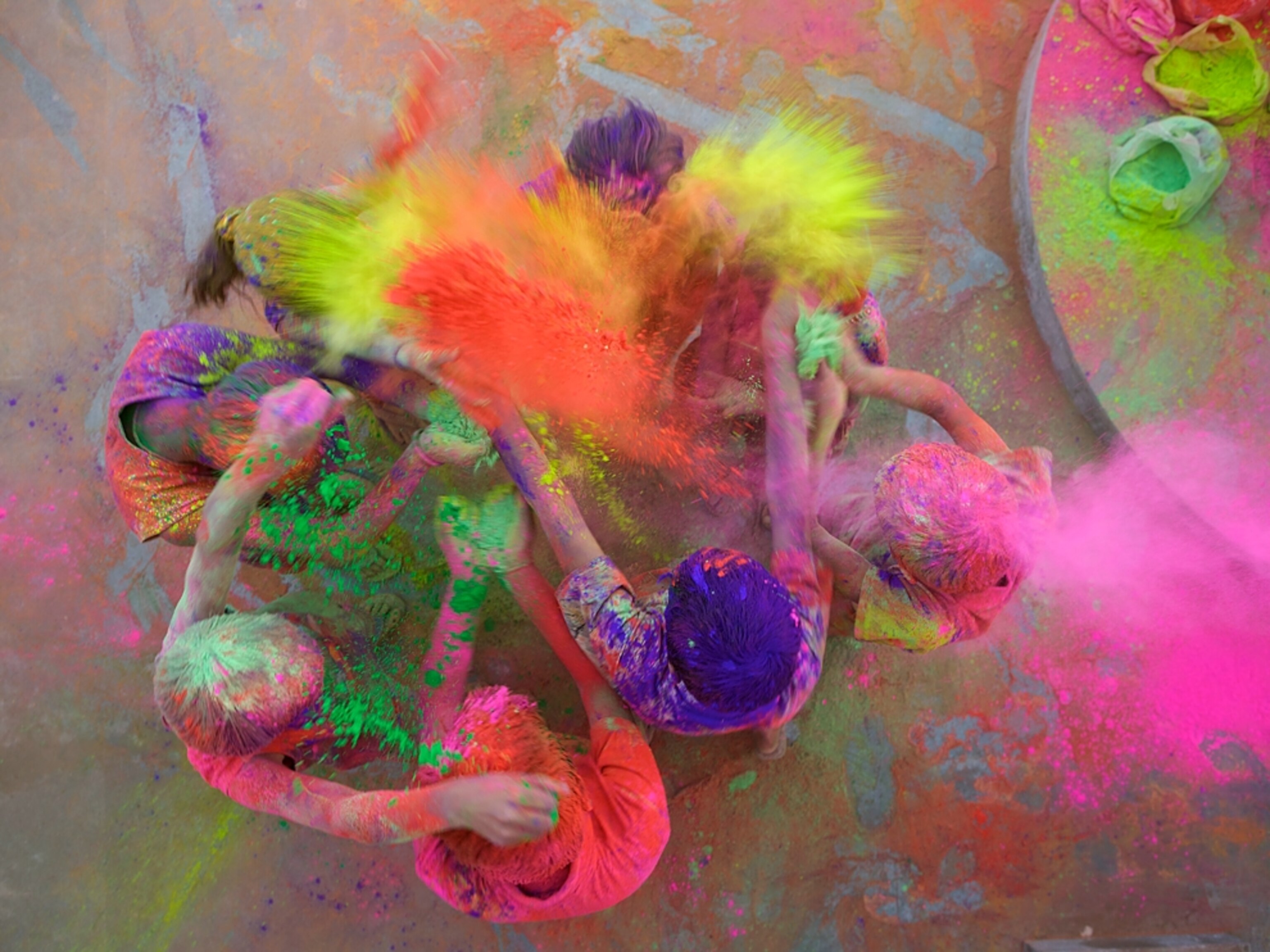 kids throwing colored powder during Holi, India