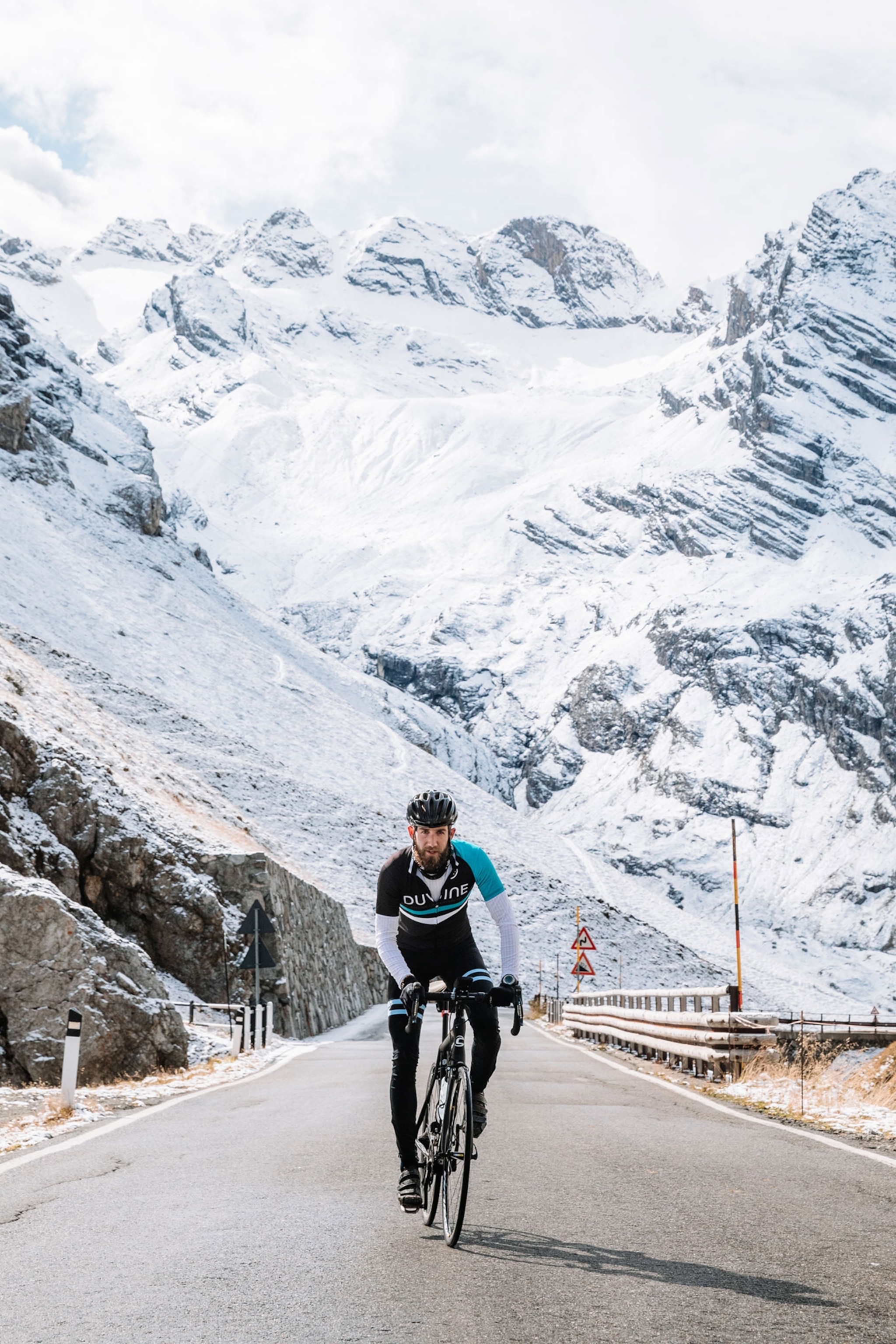 a cyclist riding through the Stelvio Pass in Italy