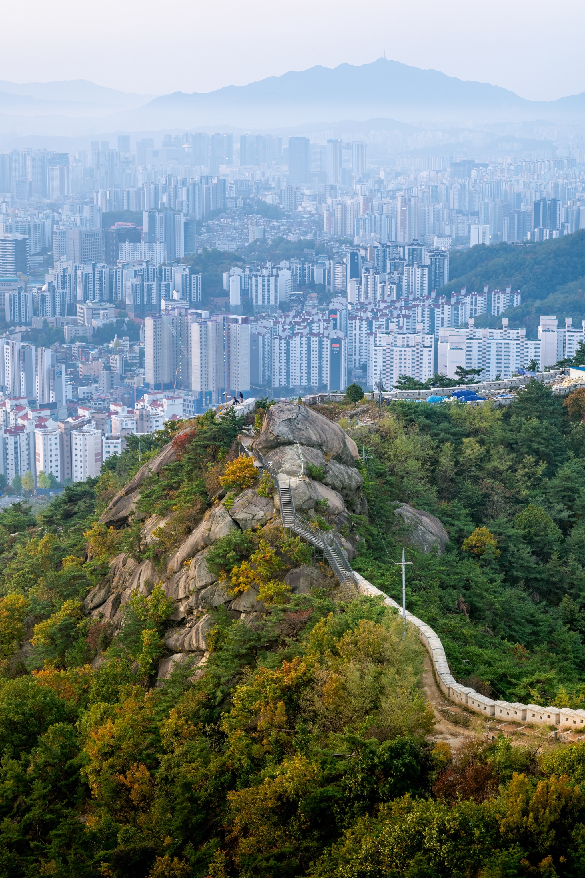 City walls and a pathway alongside them, going up a mountain