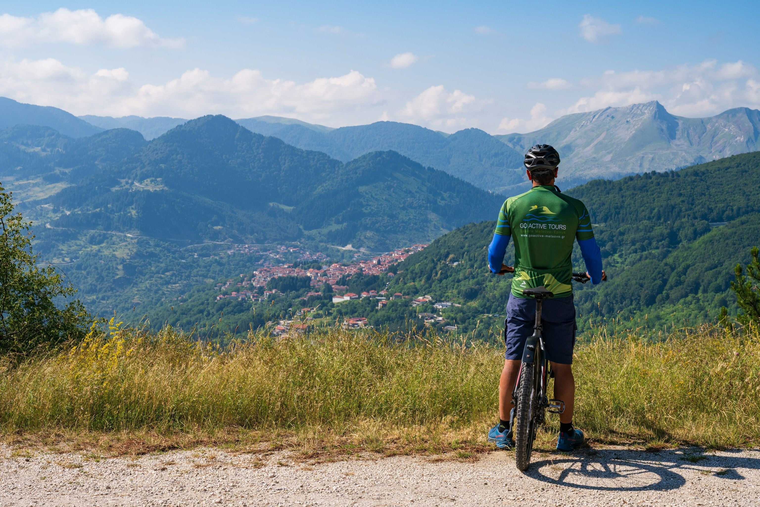 A cyclist looks out over Metsovo mountains.