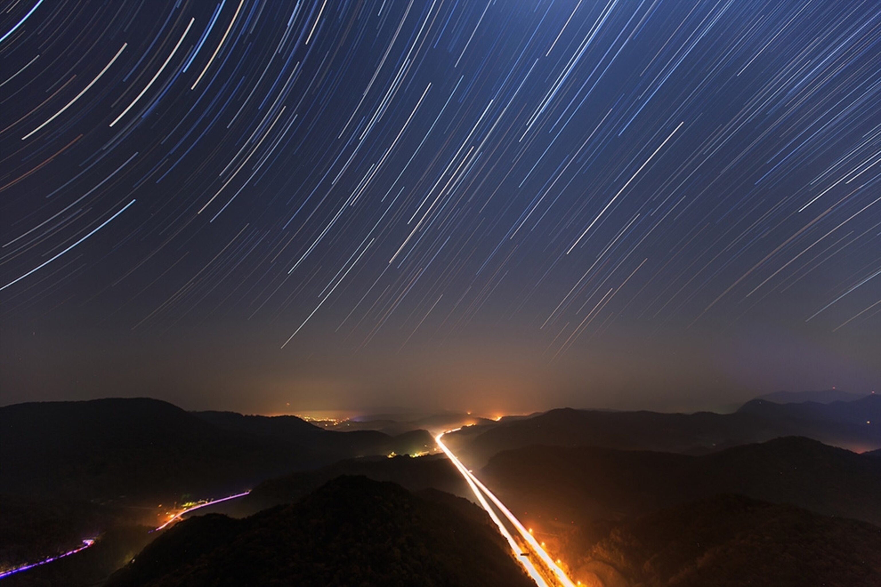 Best Space Photos 270 - A time-lapse picture of stars trailing over a highway