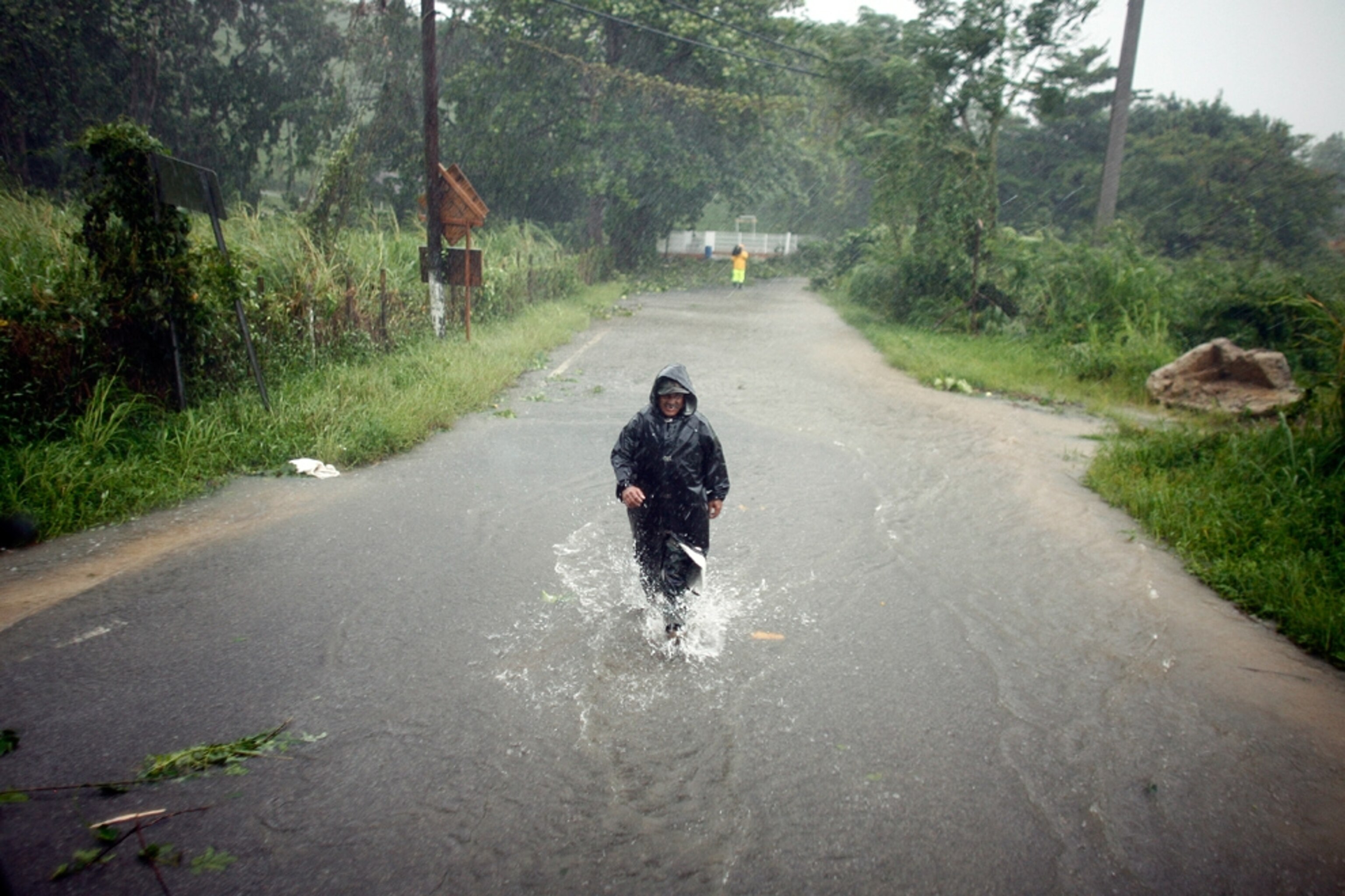A man wades through a hurricane-flooded street in Naguabo, Puerto Rico.