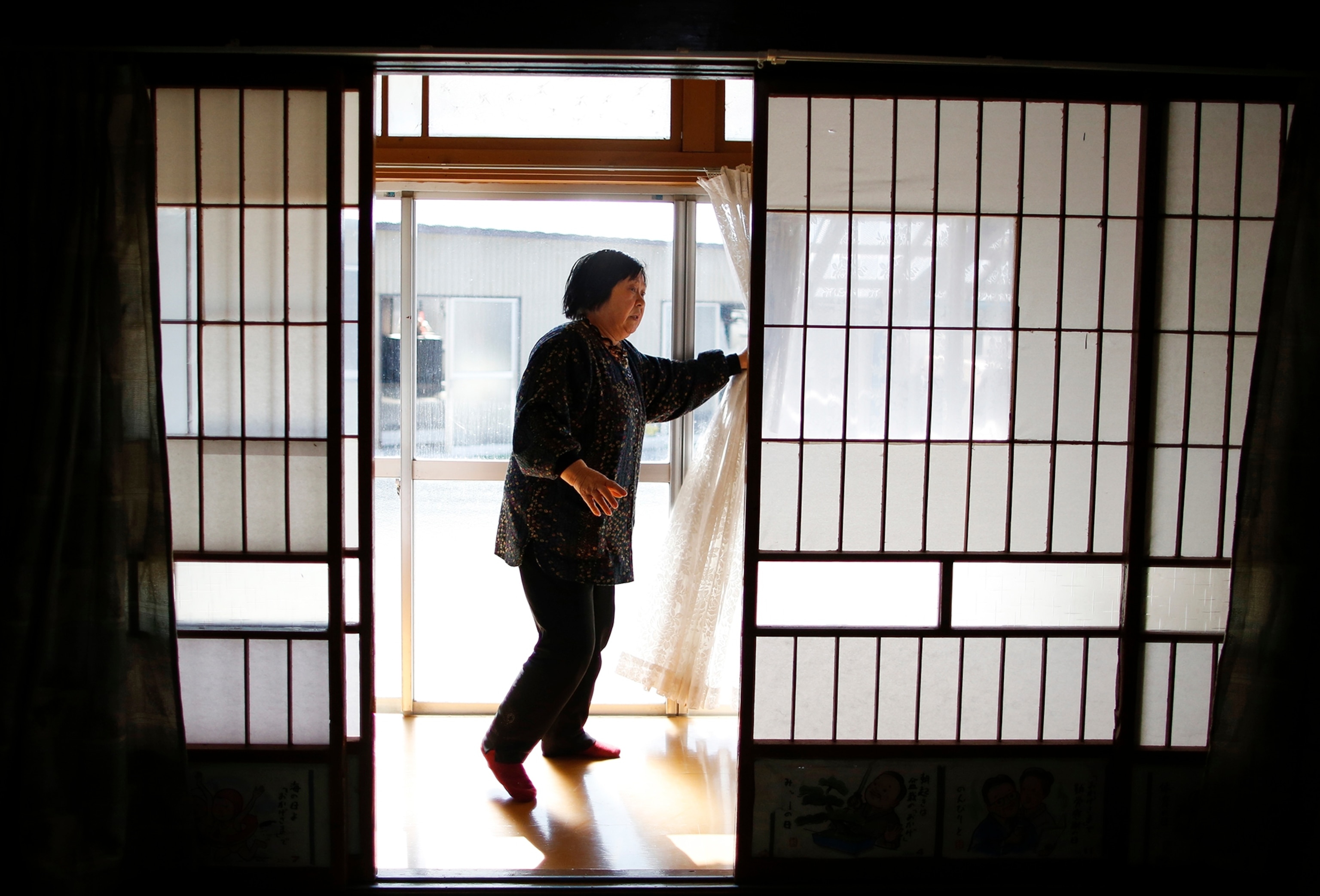 a woman returning to her home in Fukushima.