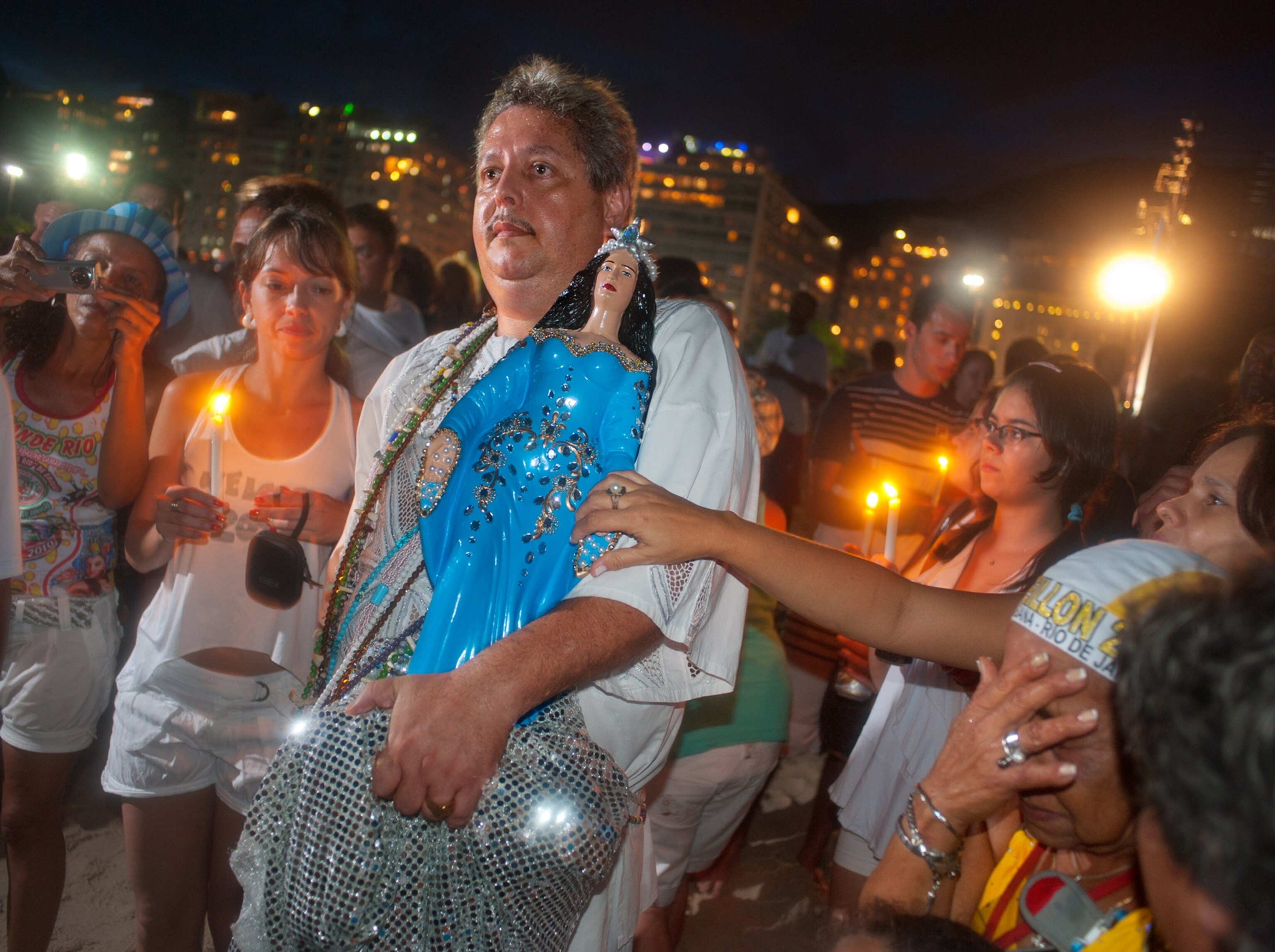 a candlelit procession along Copacabana beach to honor the goddess of the sea