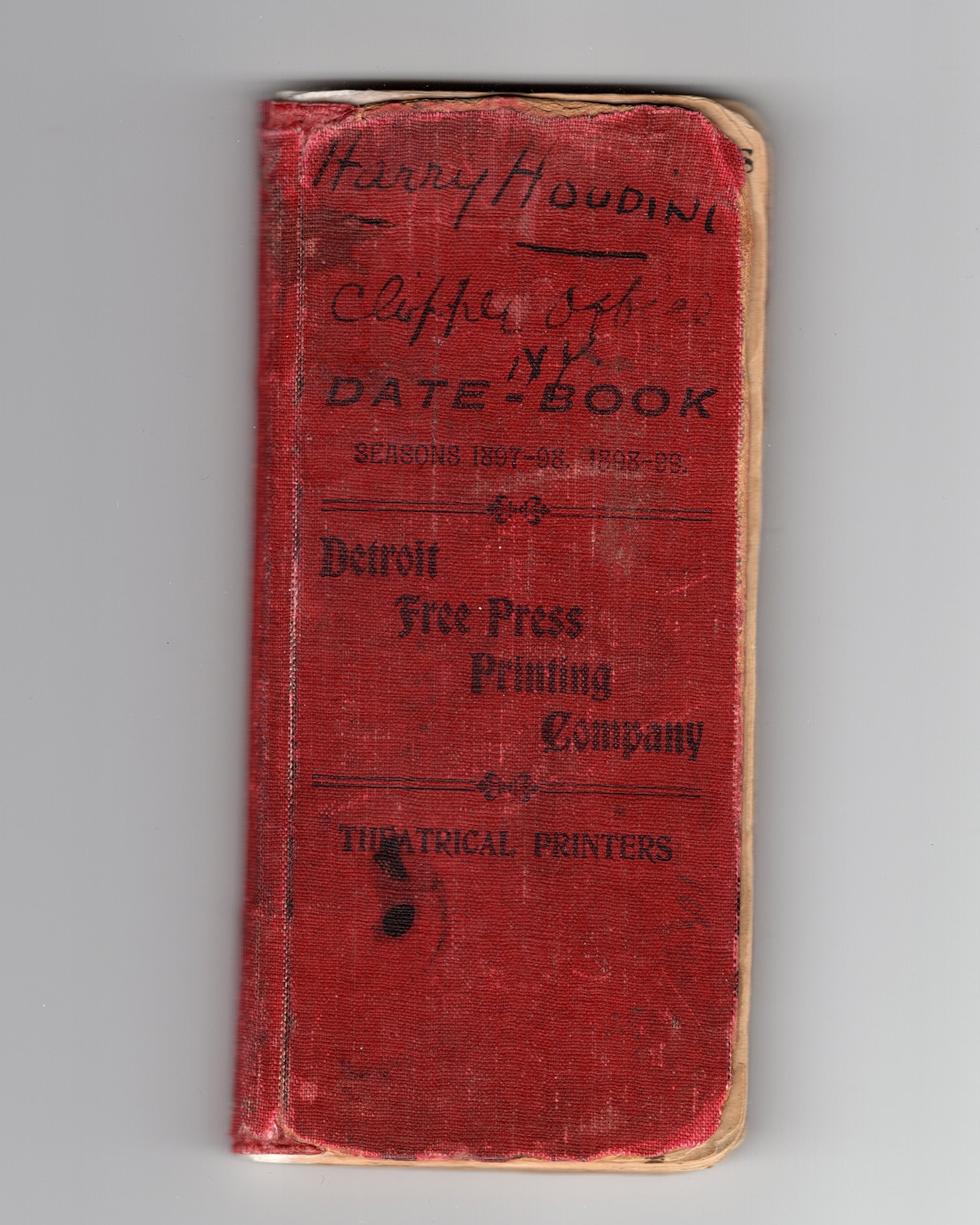 A small, worn, red date book