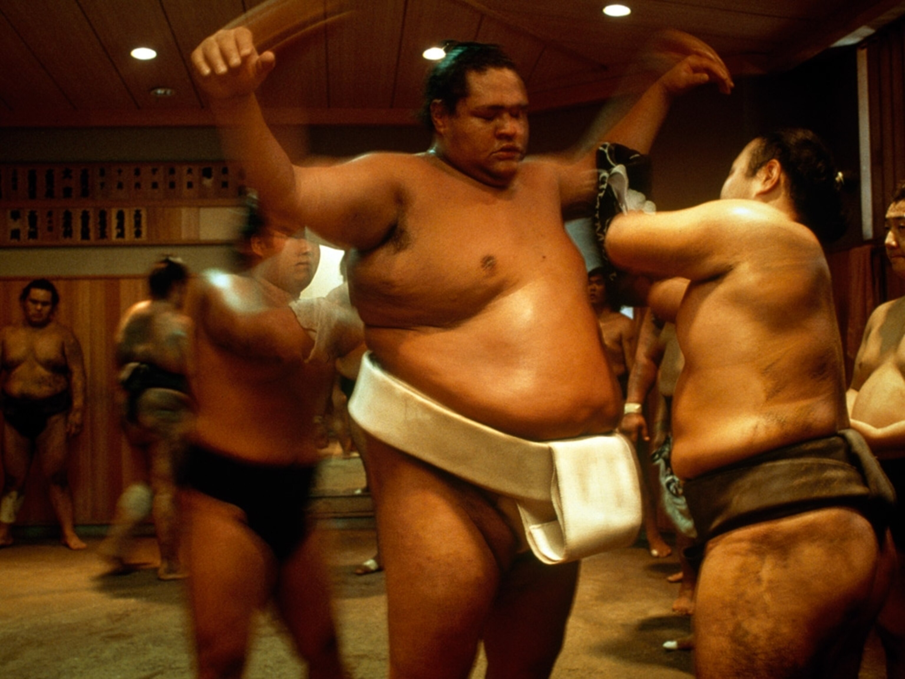 Sumo wrestler sponges off another wrestler