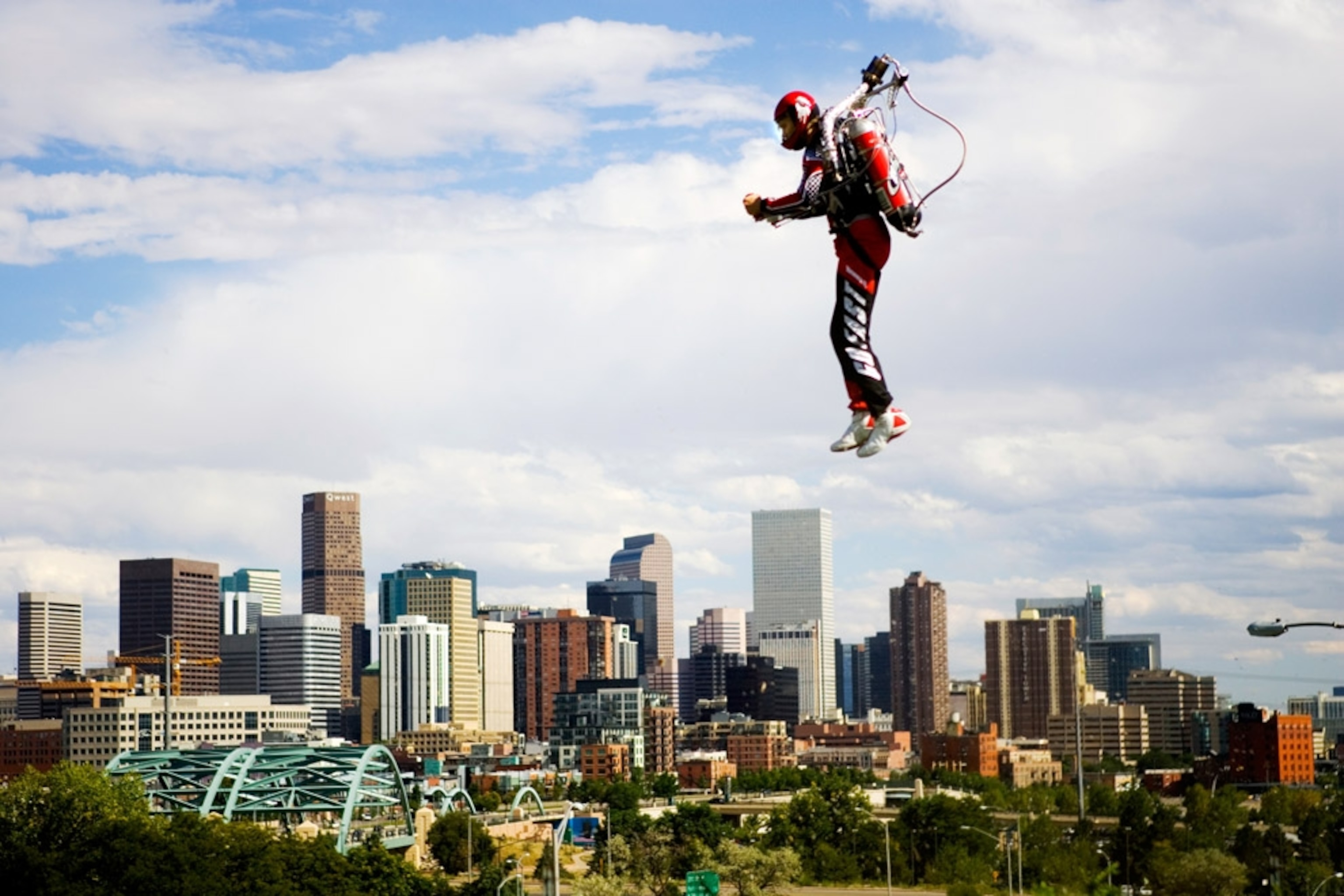 A jet pack flier hovers over Denver, Colorado