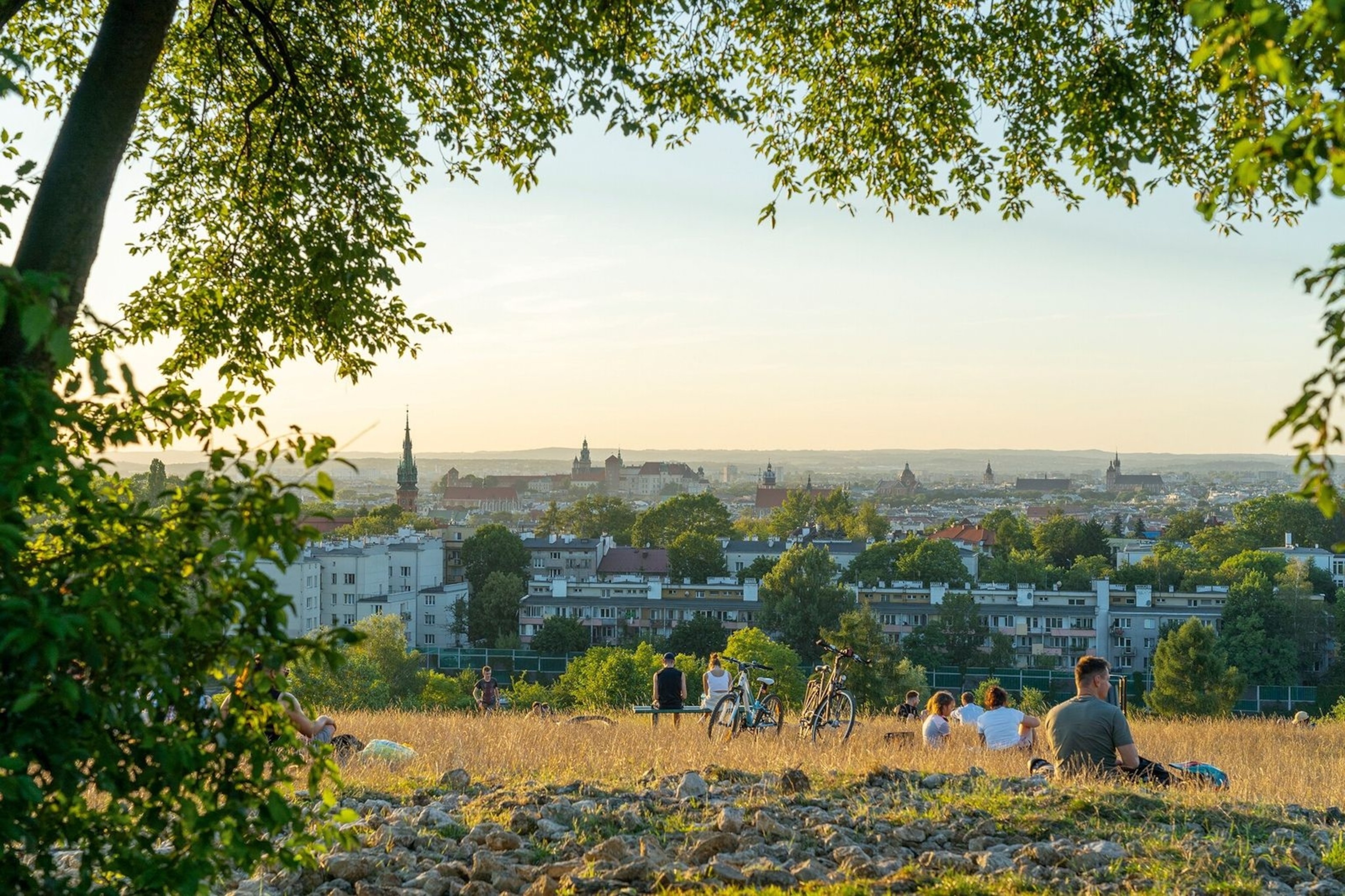 Cyclists taking a break on Kraków Mound, overlooking Kraków Old Town.