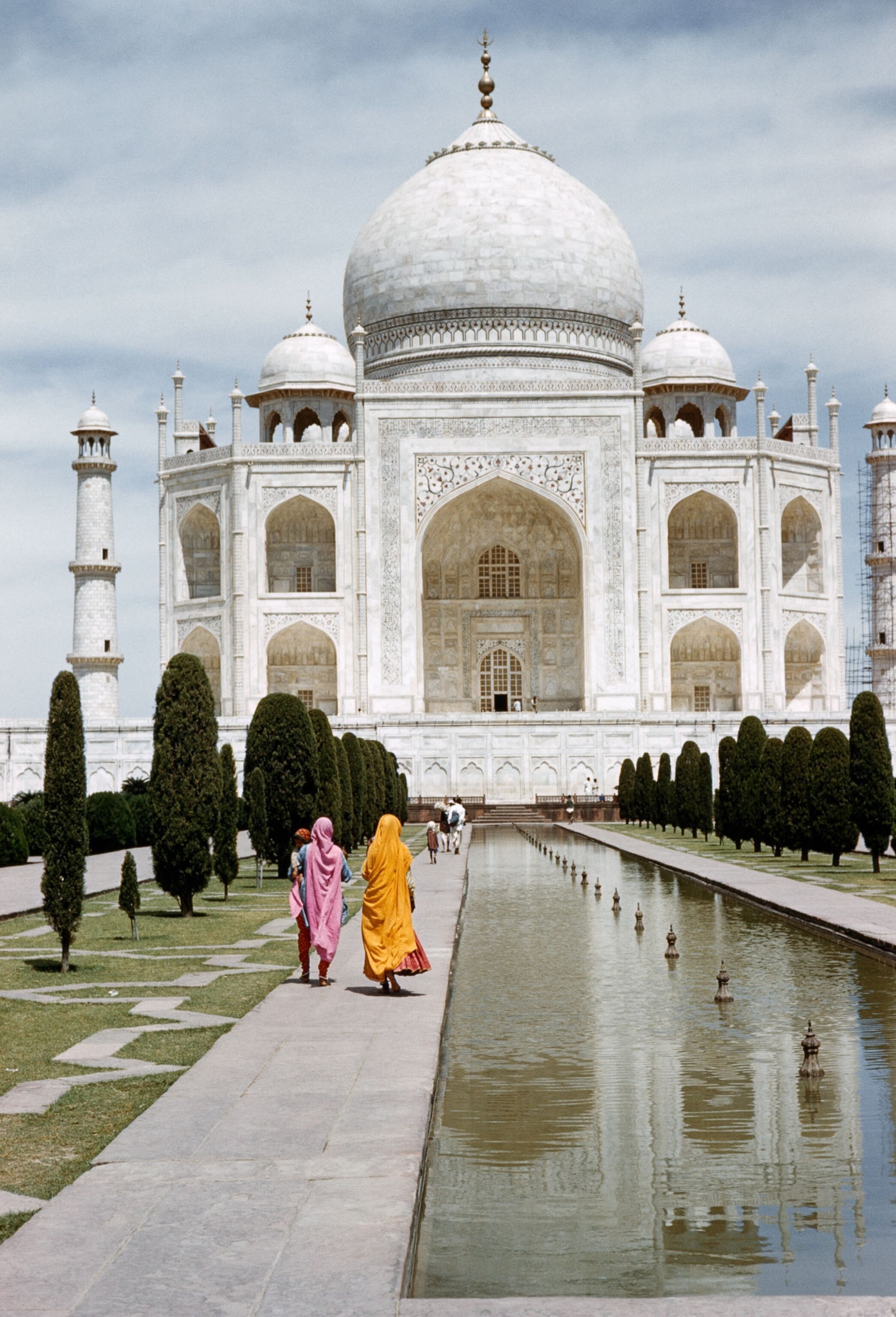 people walking by taj mahal