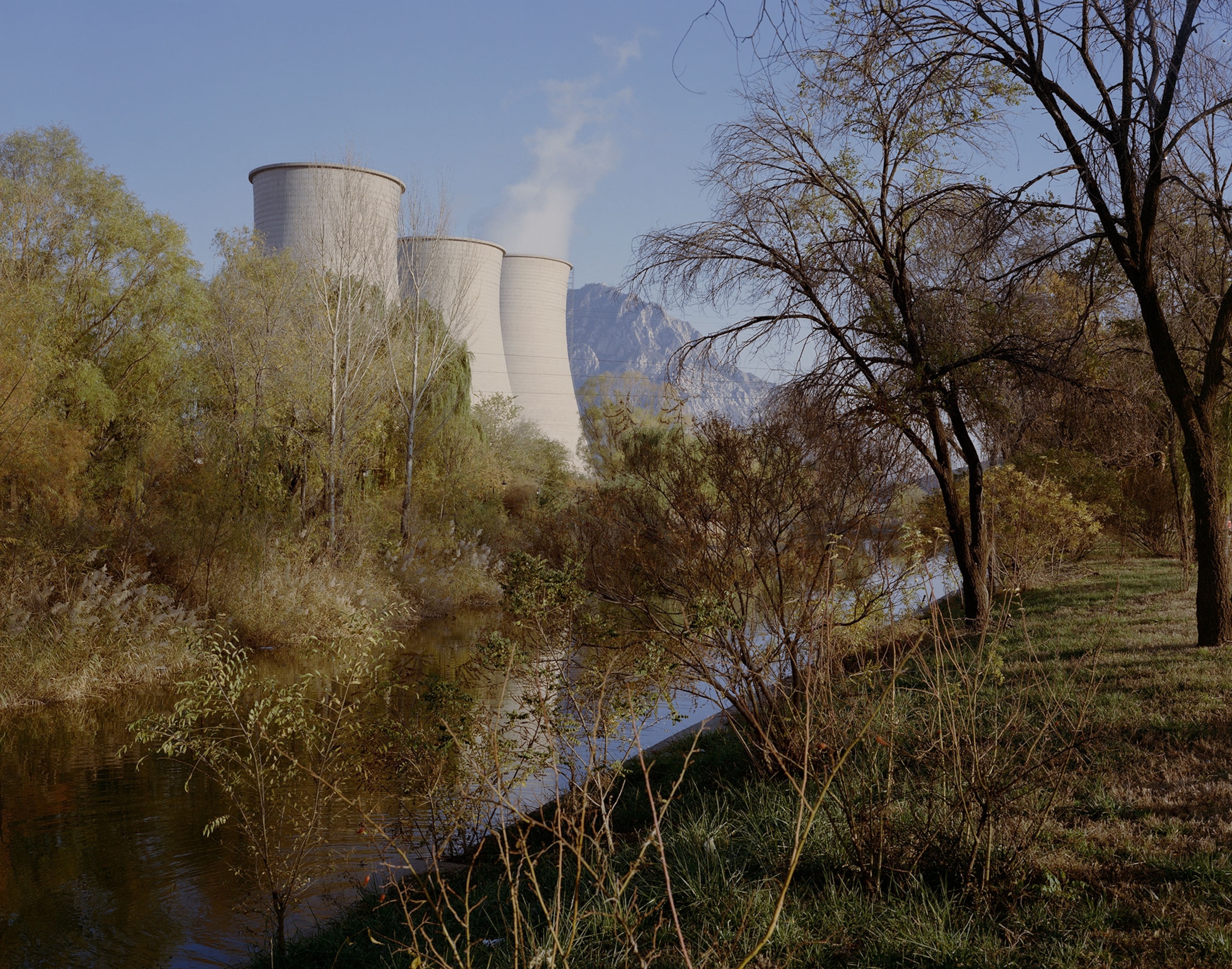 three cooling towers at a power plant