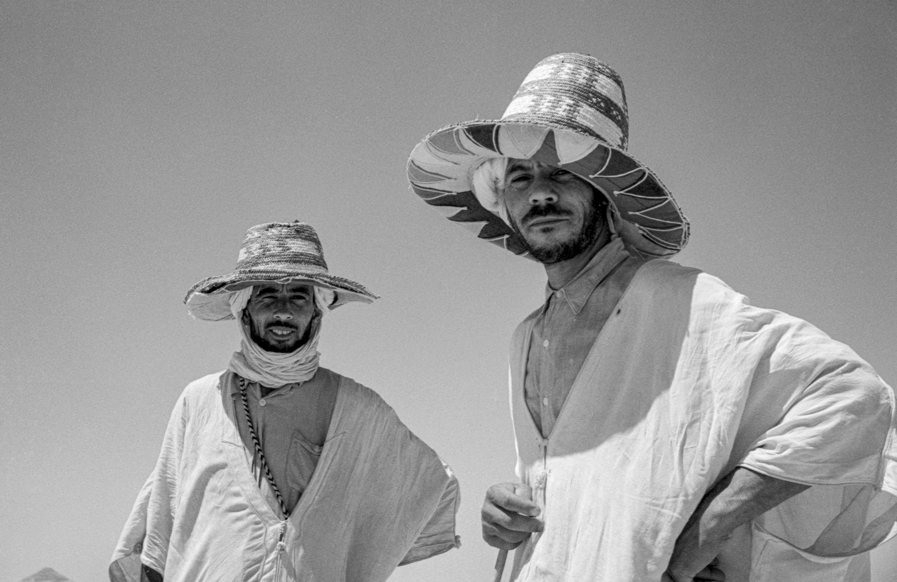 Two men in hats look at the camera