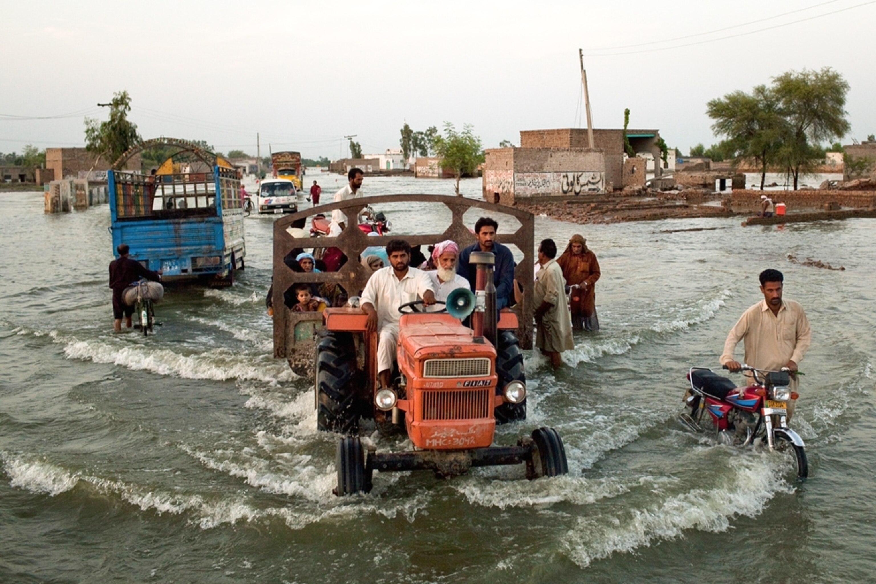 Pakistani villagers evacuating their farms after the floods