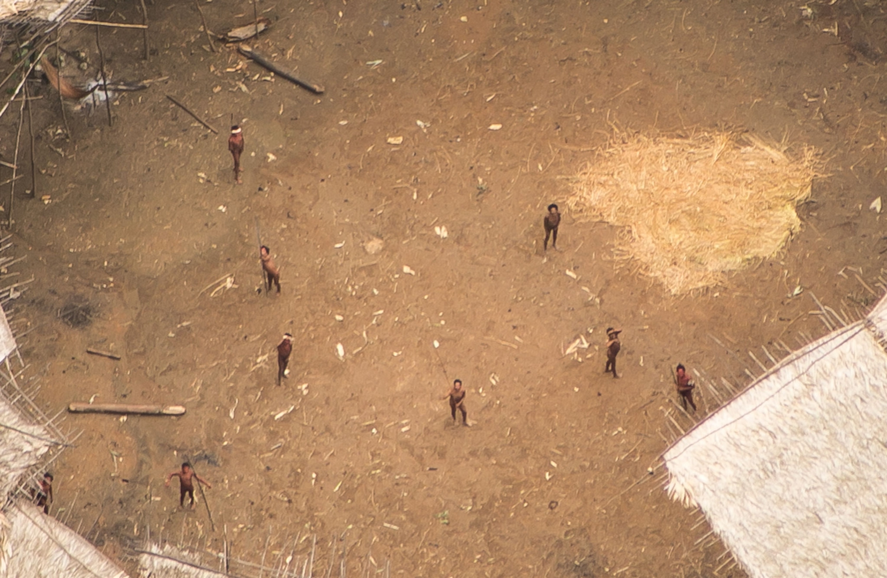 an uncontacted tribe looking up at a camera from below