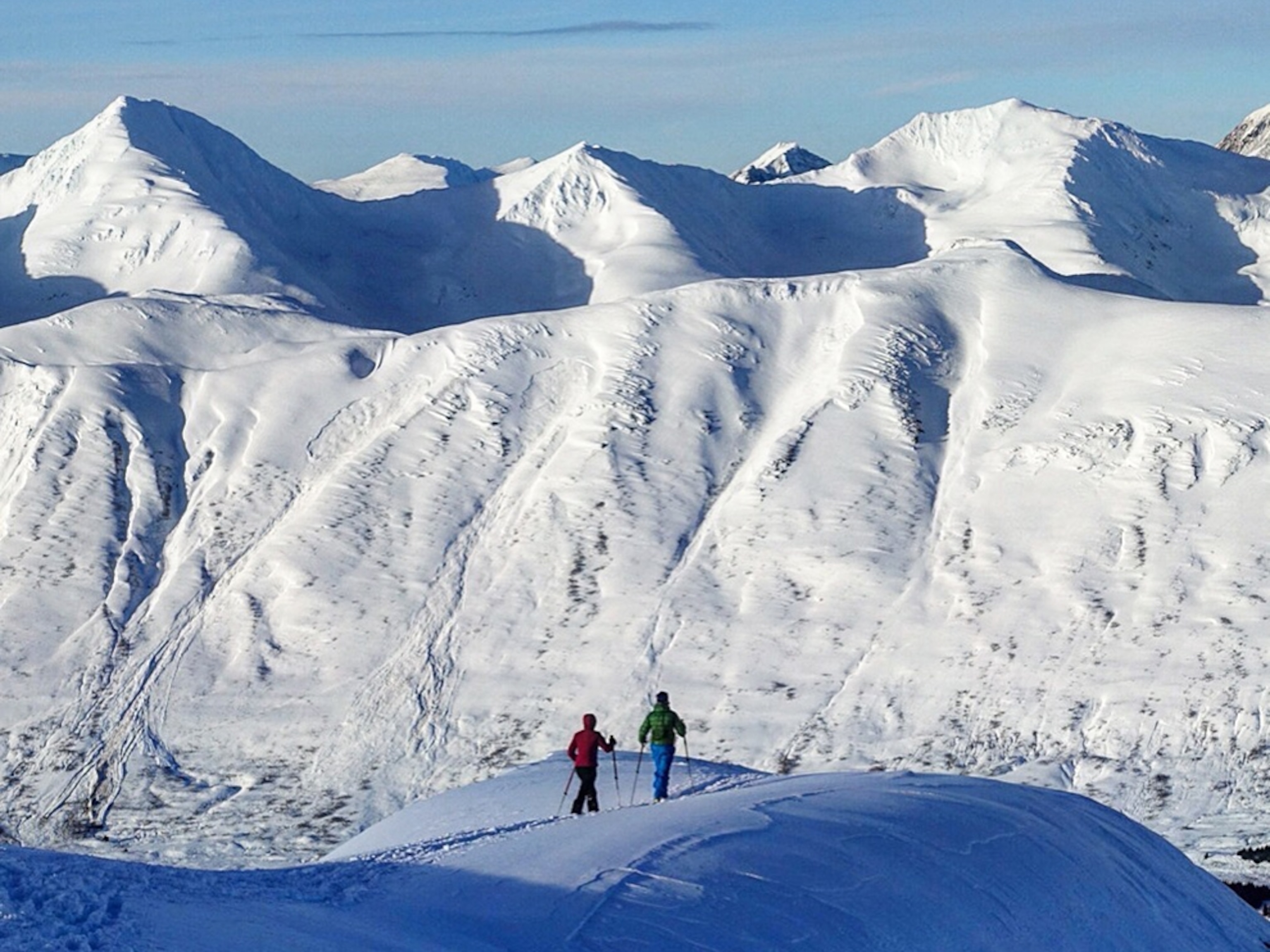hikers hiking through a mountainous valley