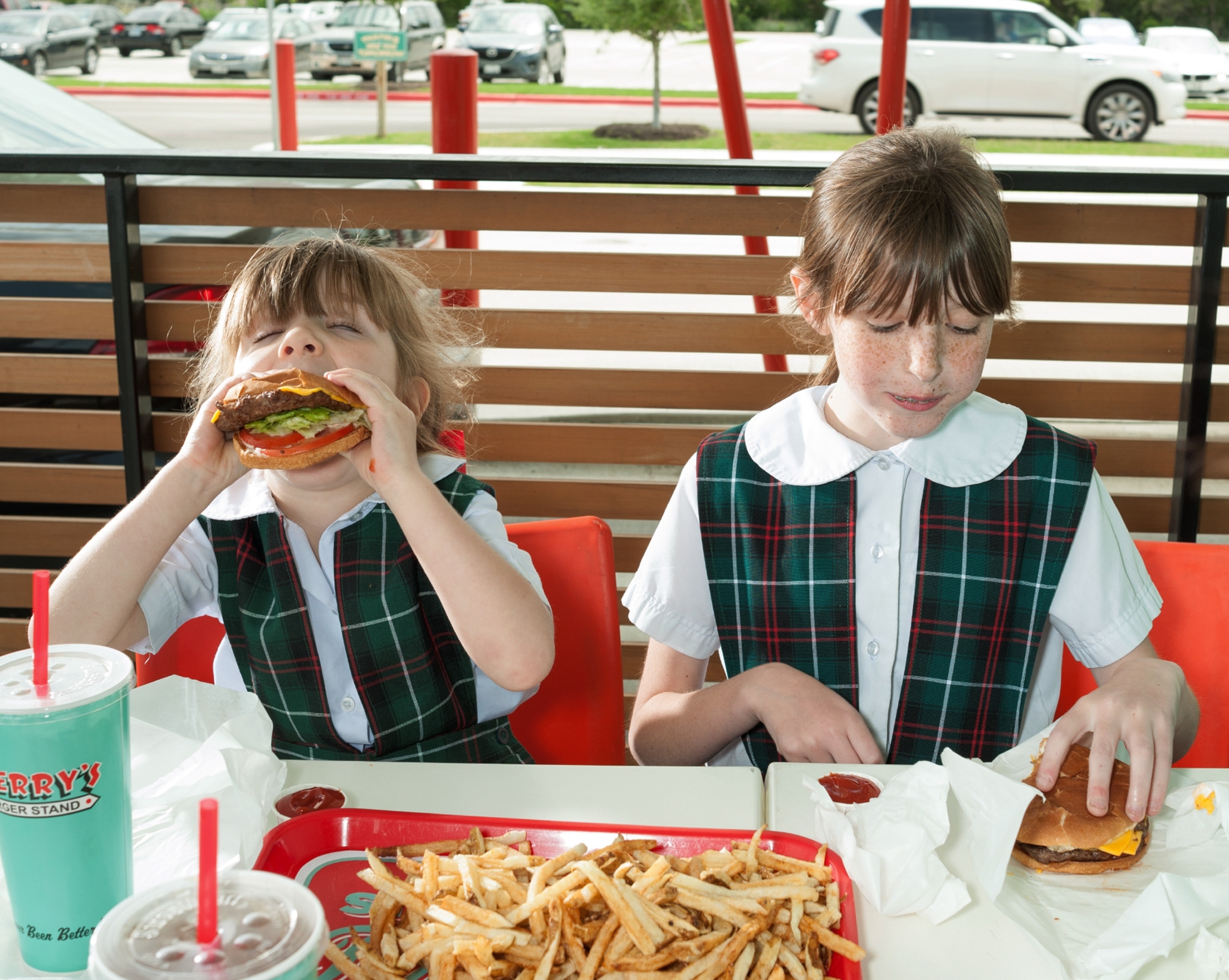 sisters eating hamburgers at a stand in Austin