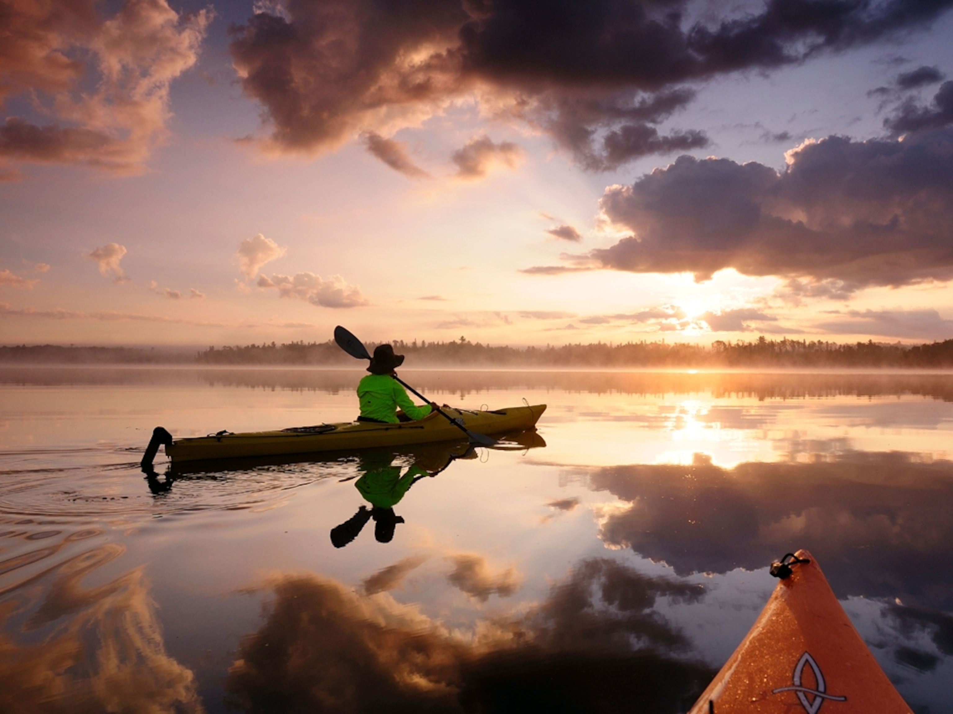 Woman kayaking on quiet lake