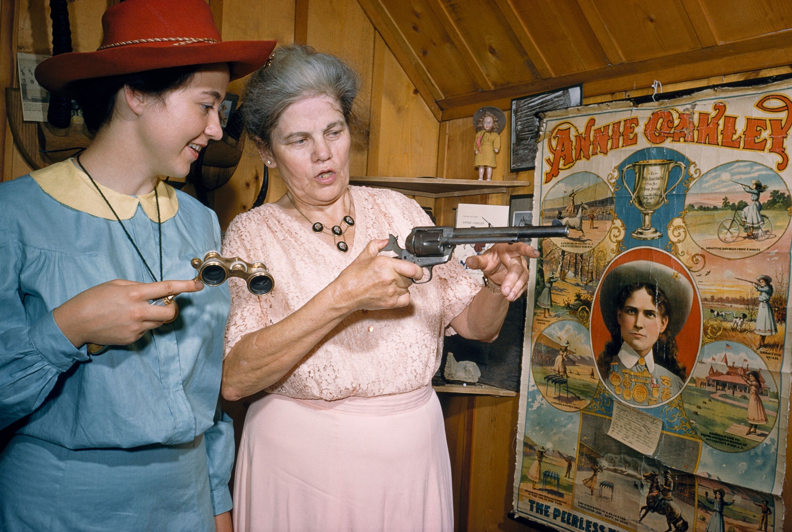 Annie Oakley's niece showing off mementos to woman costumed as Annie