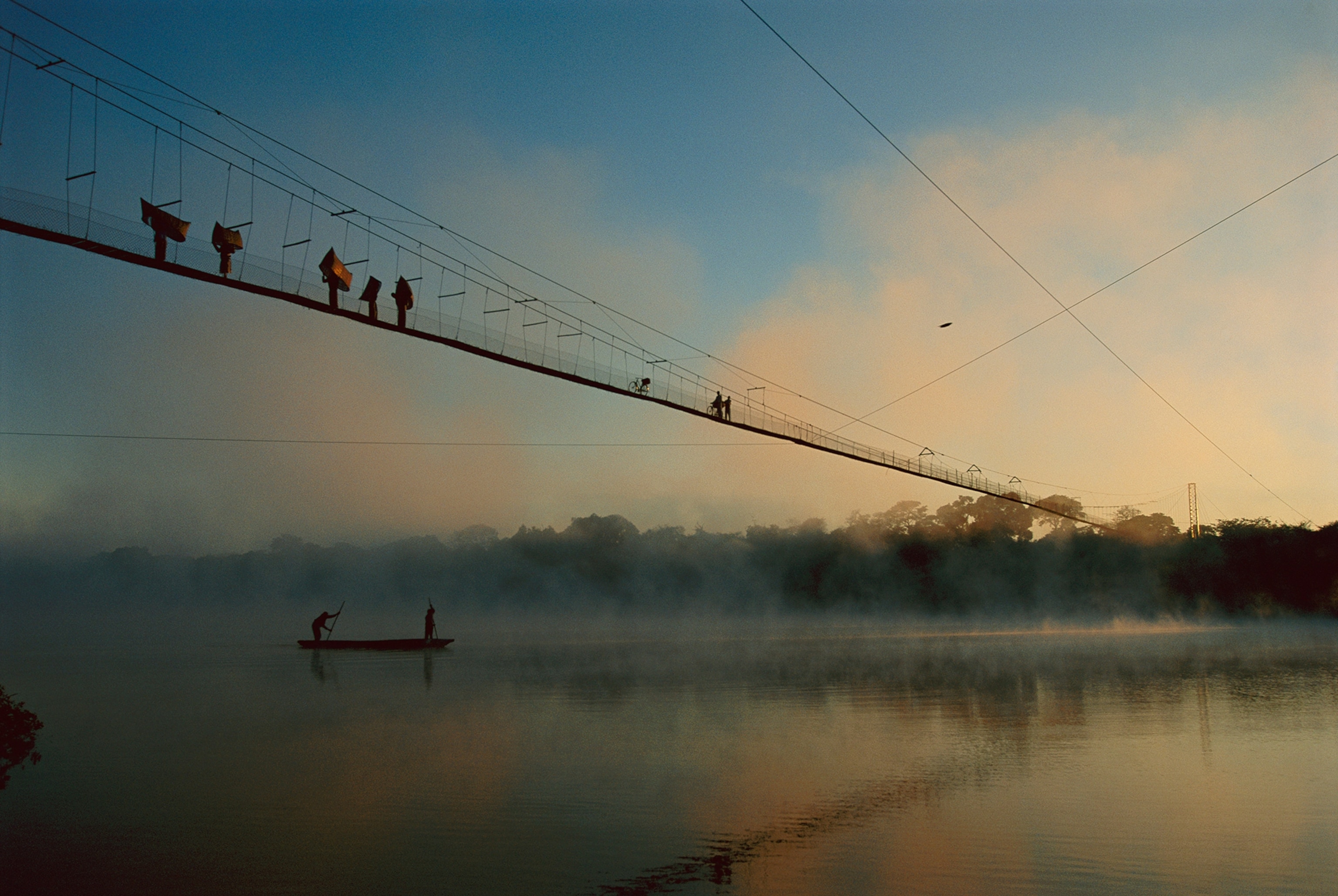 People on a 700-foot-long cable bridge spanning the Zambezi River.