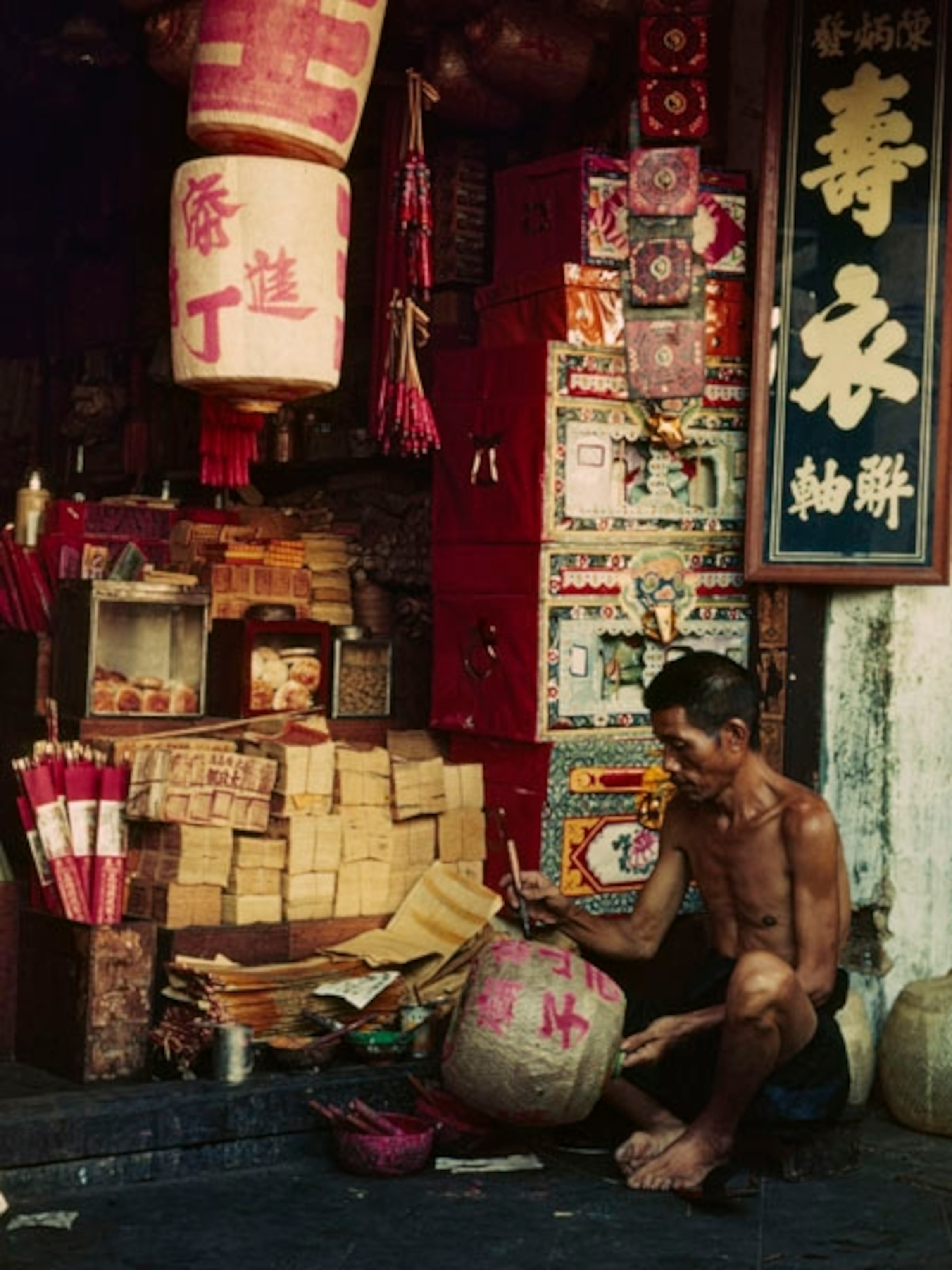A man painting a lantern
