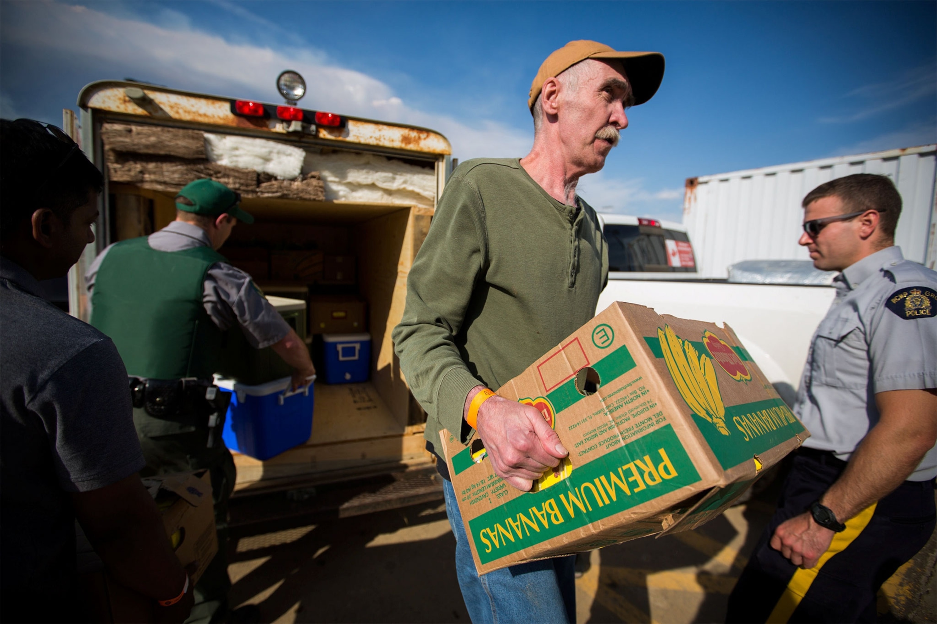 a man carrying bananas to a community center