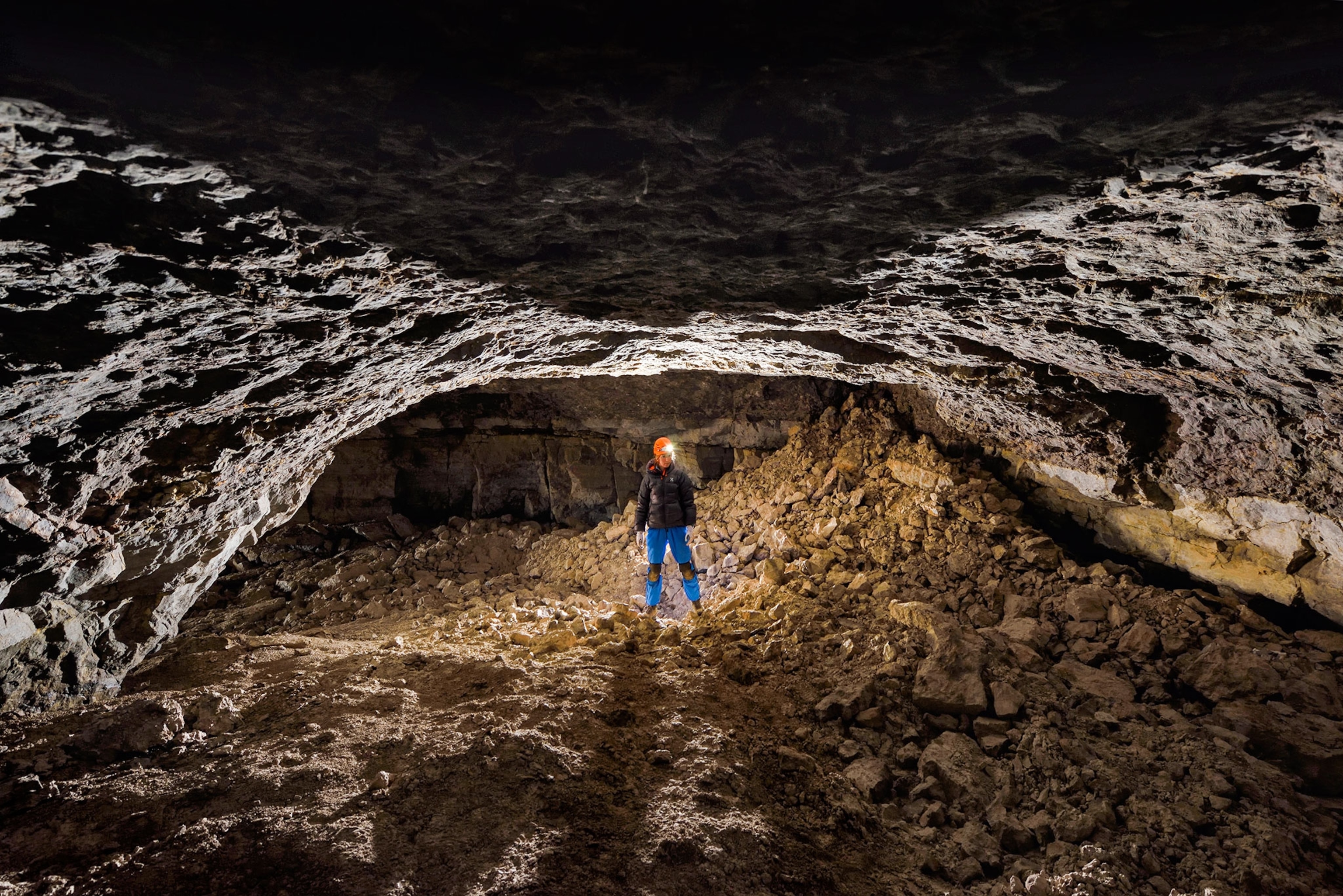 a scientist exploring a large cave