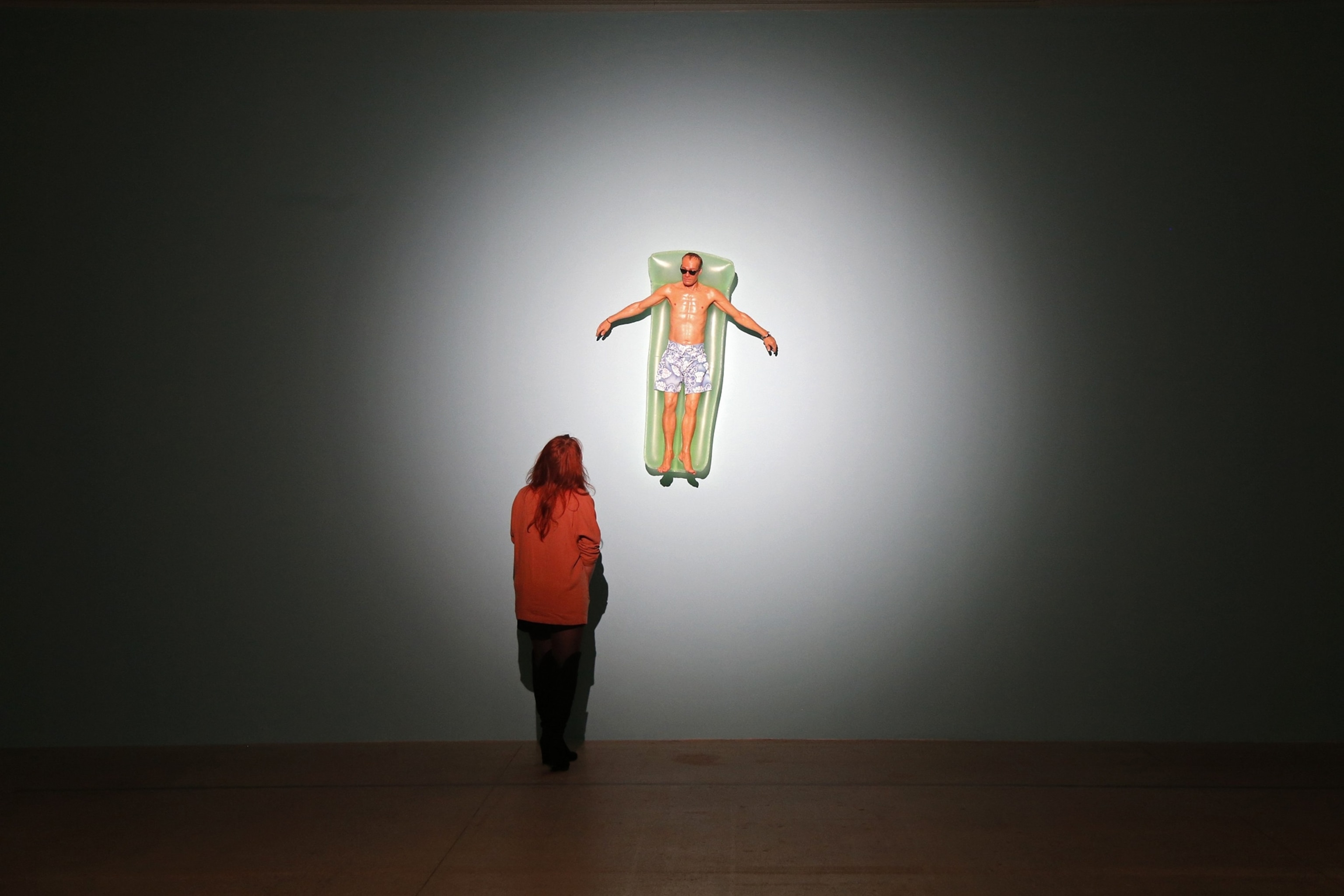 a woman looking at an art exhibit.