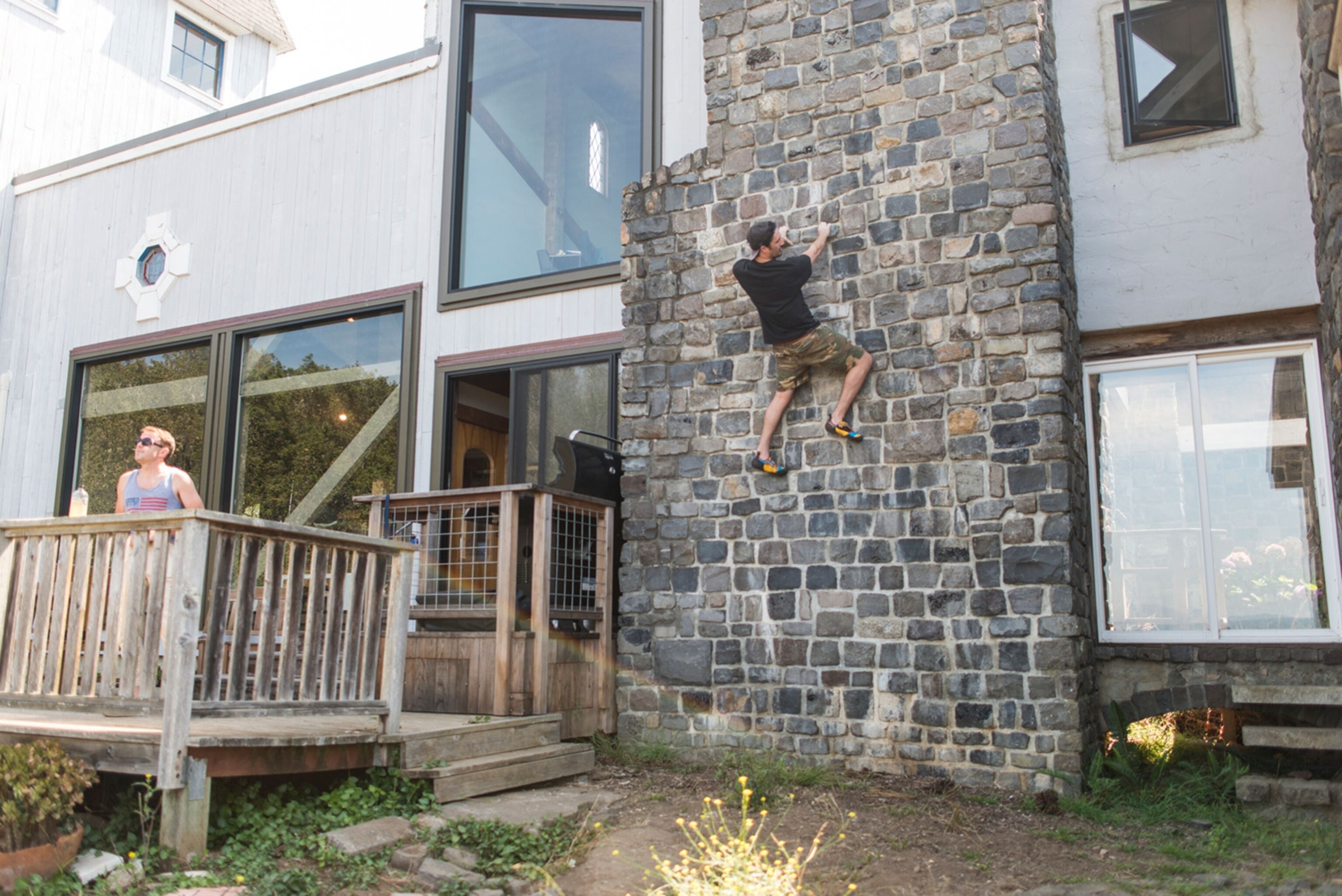 the Head and the Heart band member Kenny Hensley climbing on a brick wall