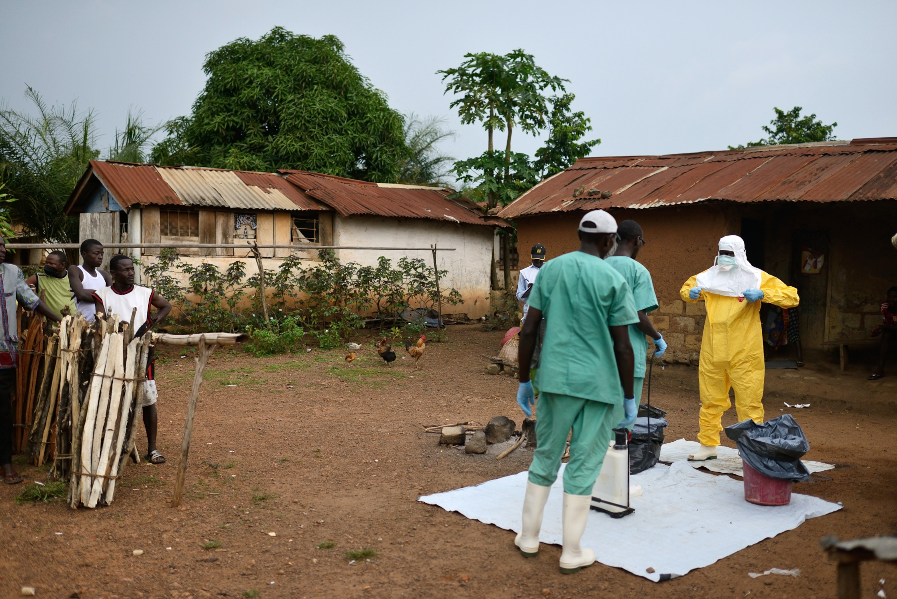 Residents of Bawa and other nearby villages listen to the regional prefect speak about Ebola in their district.