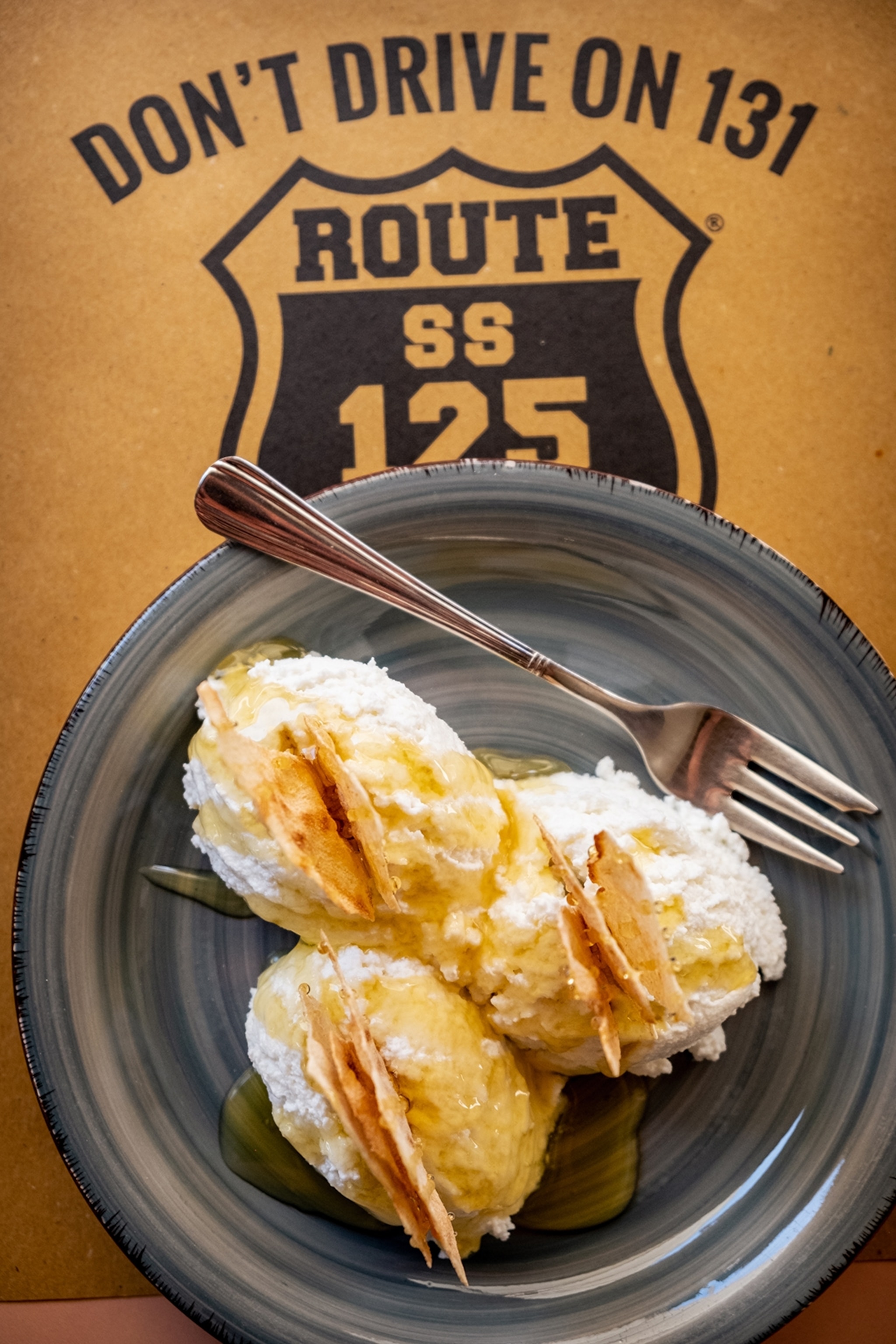 A plate with goats cheese and honey