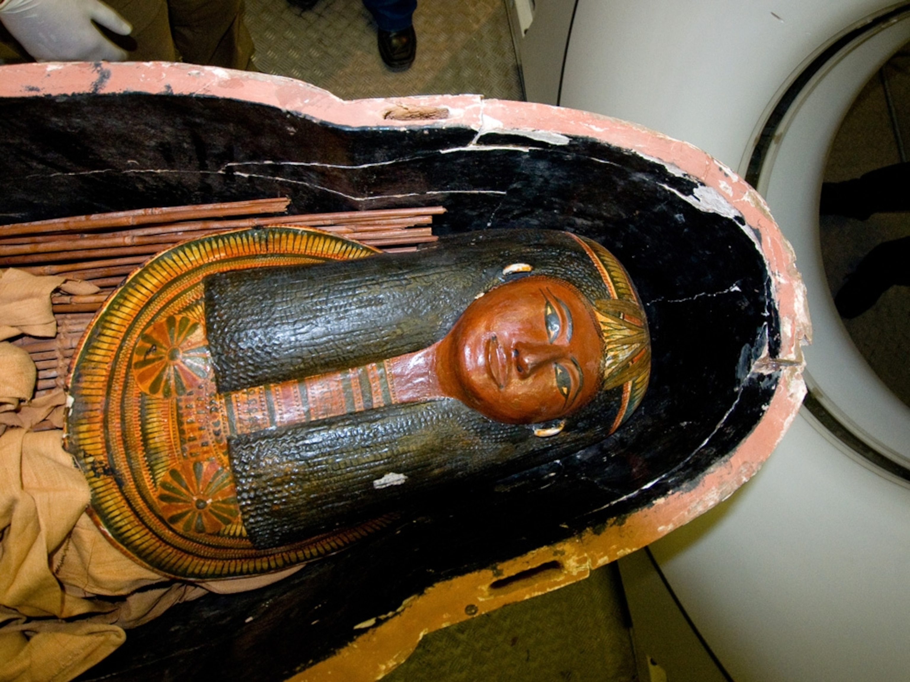 Egyptian mummy picture: The sarcophagus of a female mummy heading into a CT scanner