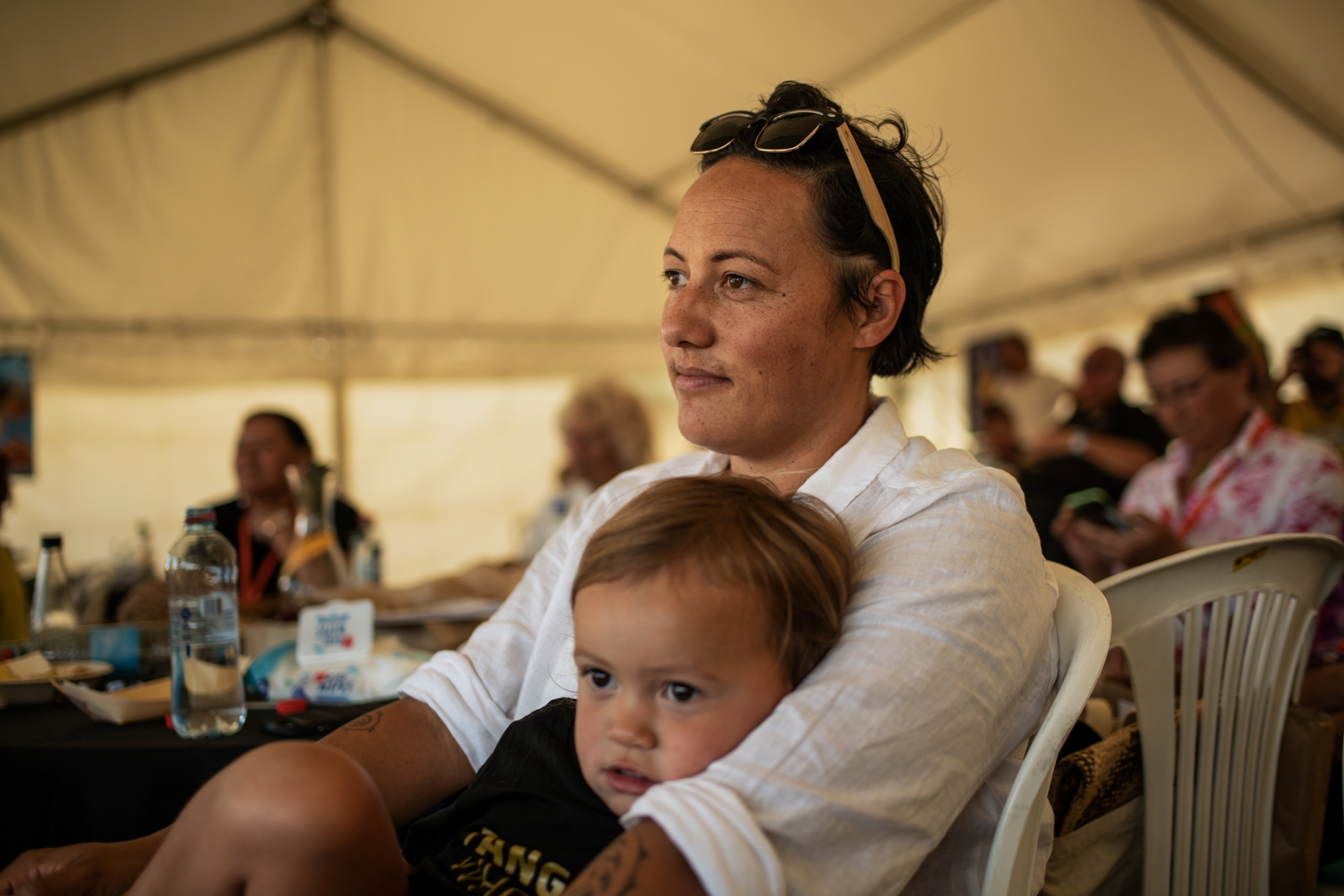 a child sitting in her mother's lap