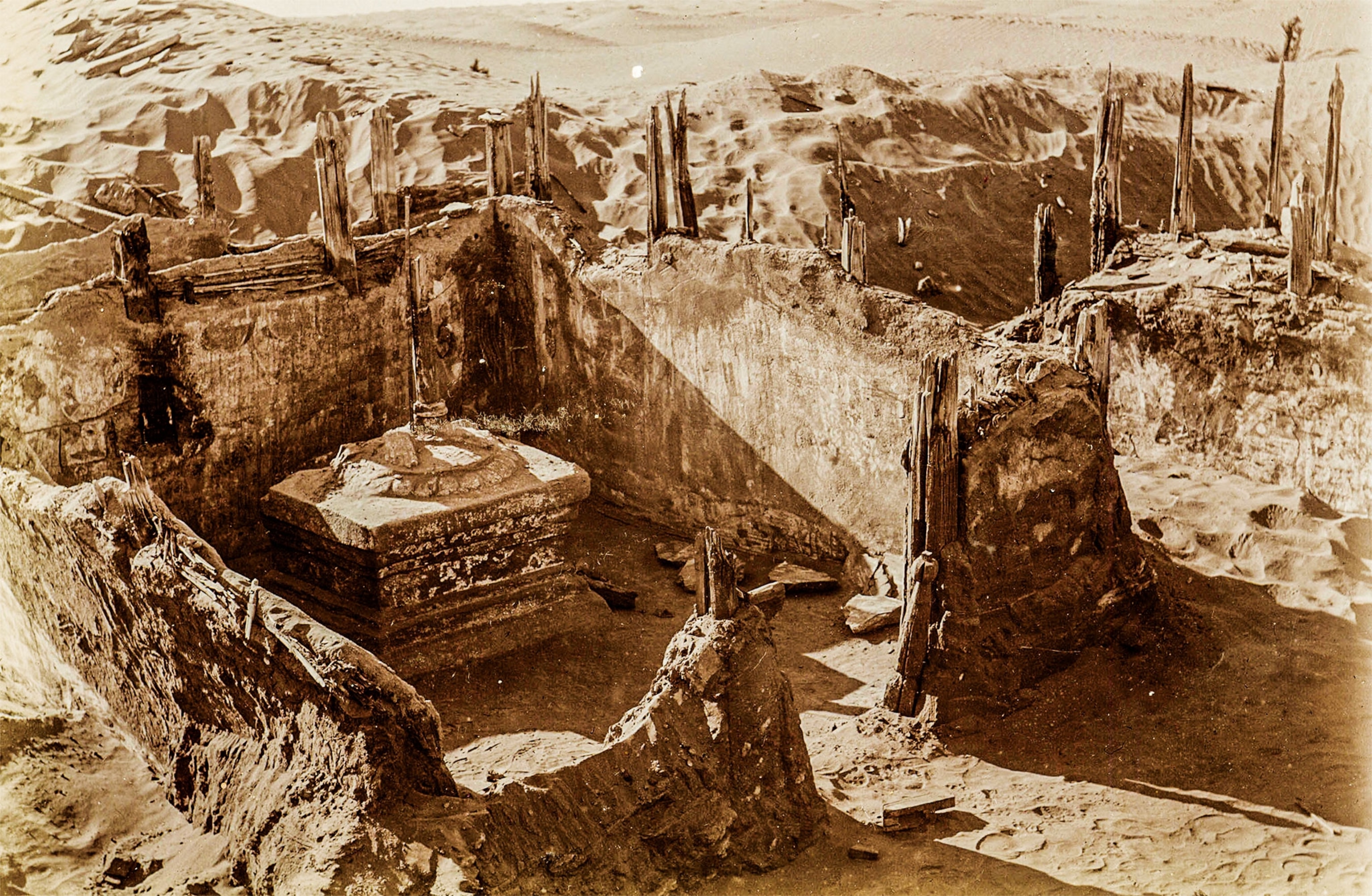 A sepia toned photograph of an excavated Buddhist temple