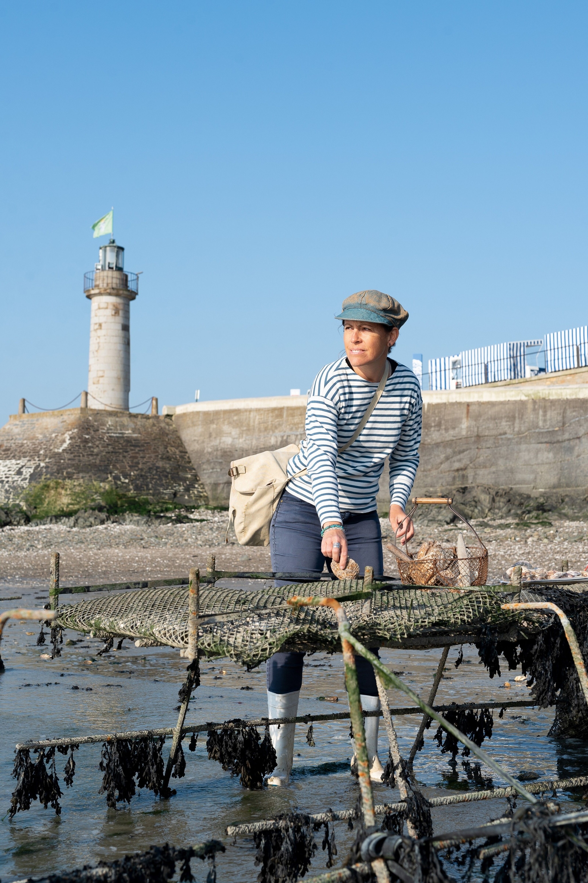 Tour company owner Inga Smyczynski among the oyster racks in Cancale.