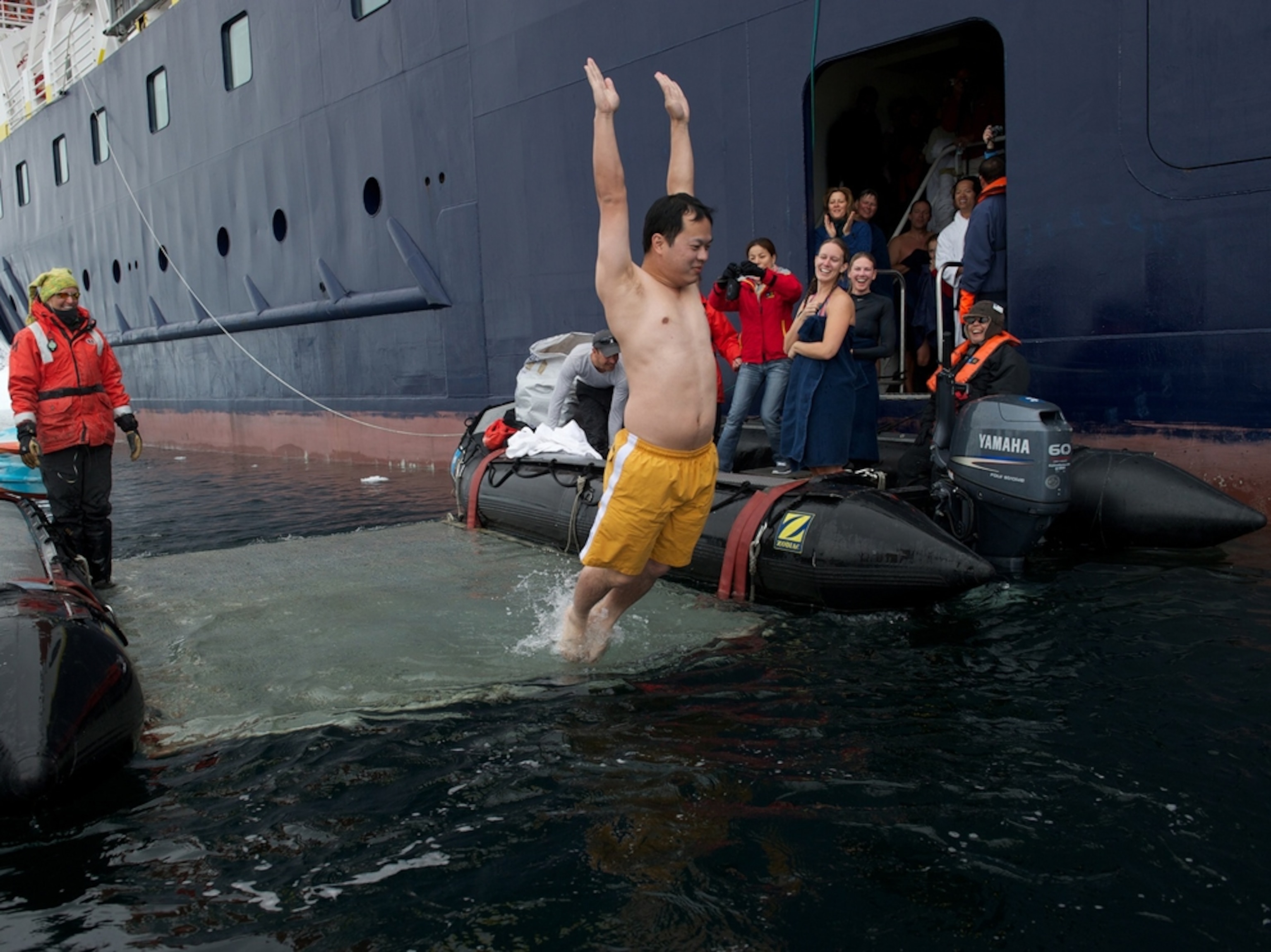 a man jumping in water in Antarctica