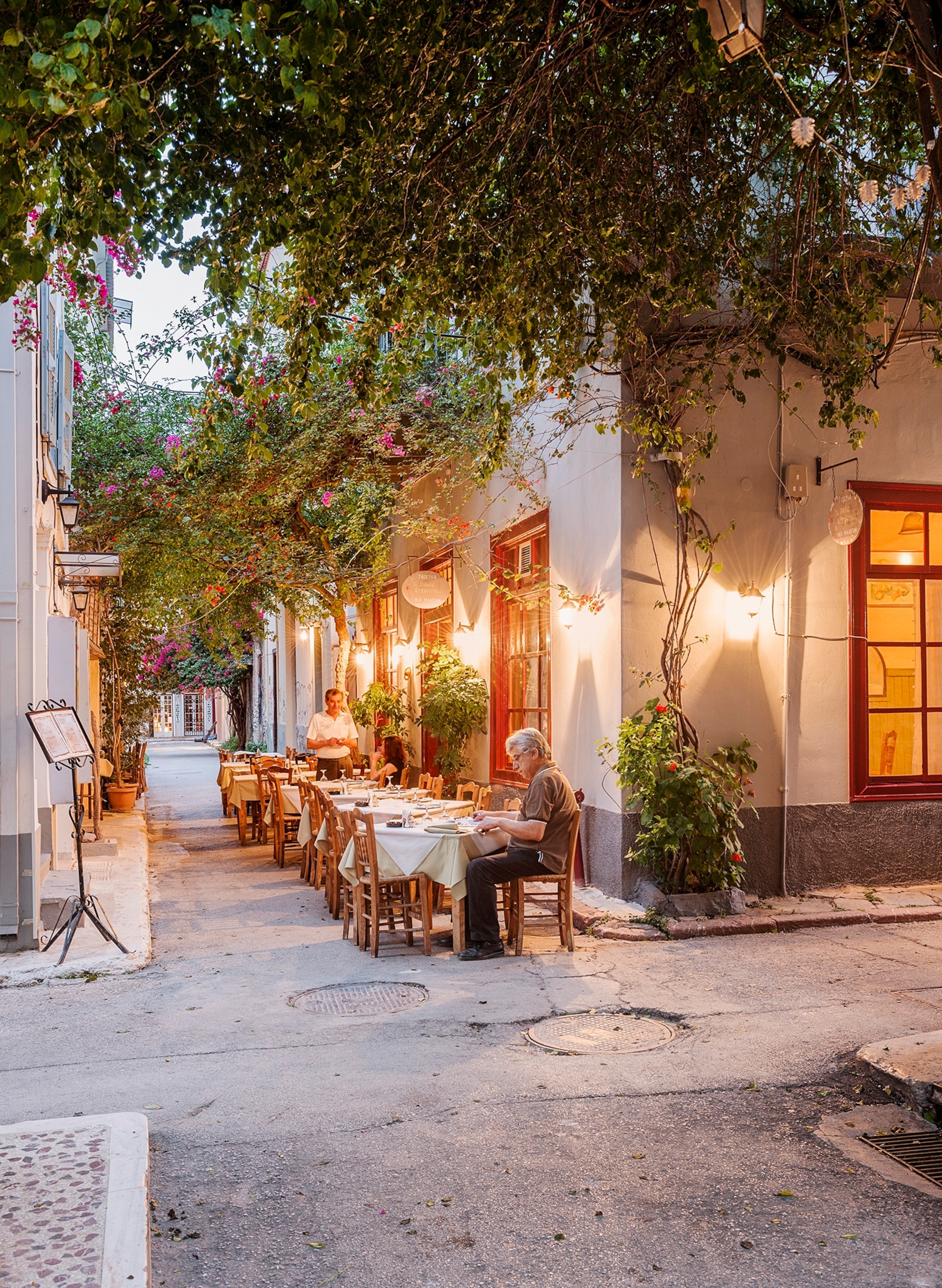 Greece, Argolis, Peleponnese, Paleo Arhontiko, taverna, restaurant, evening, alley, street, gastronomy, summer, exterior view, Europe.