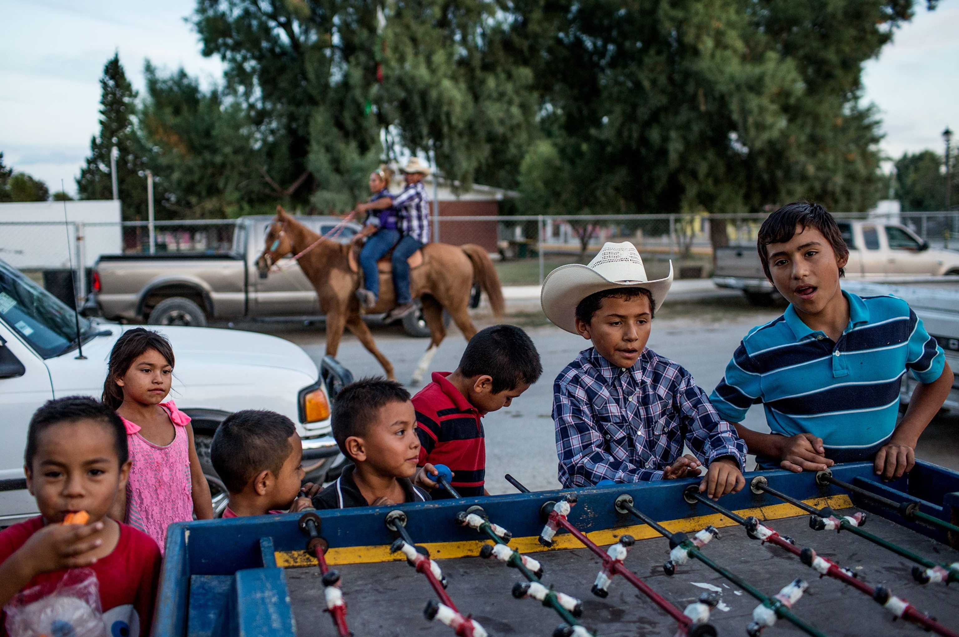 children playing foosball during a horse festival in Mexico