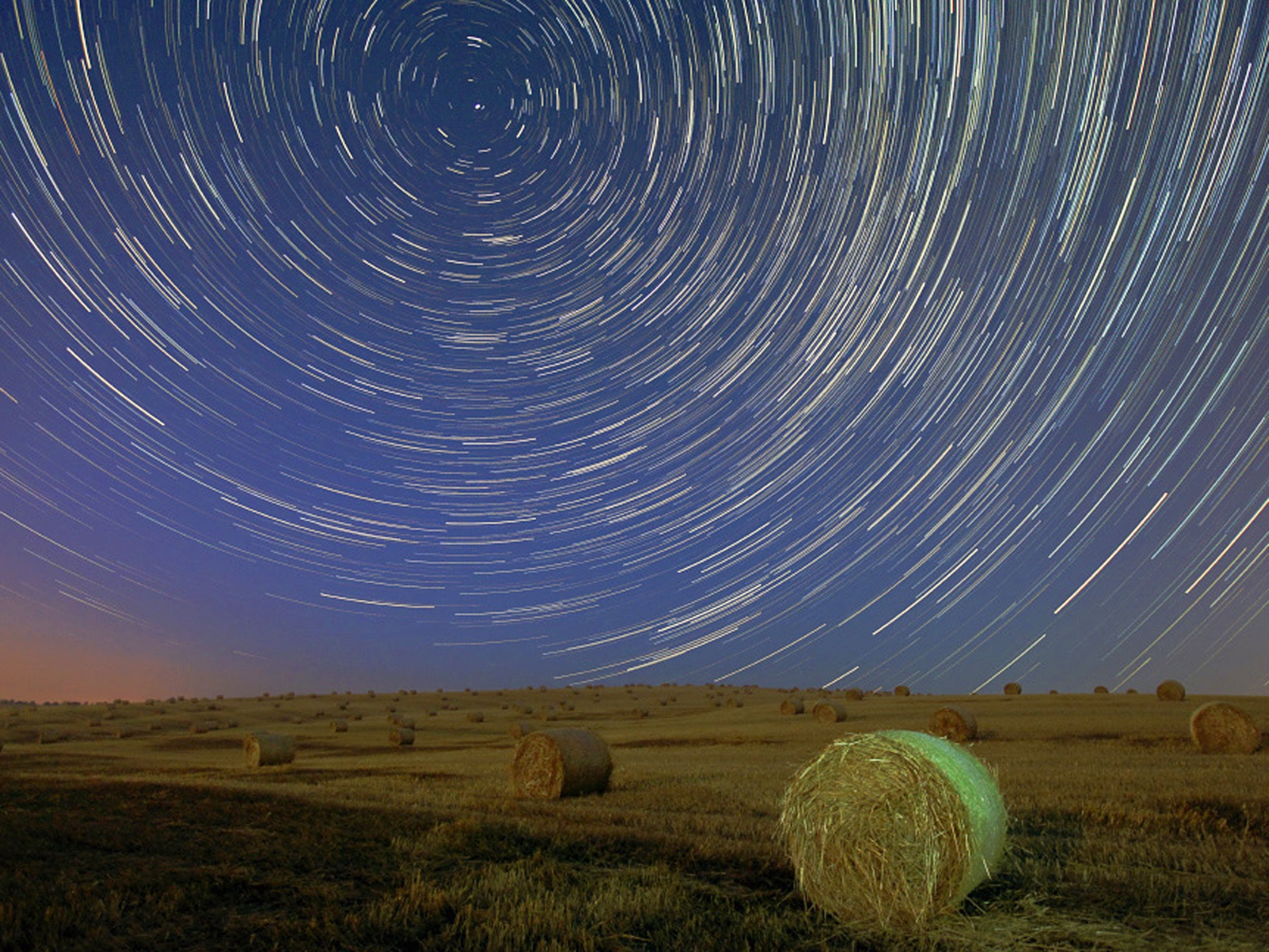 Space Pics - A picture of star trails above a field in Hungary