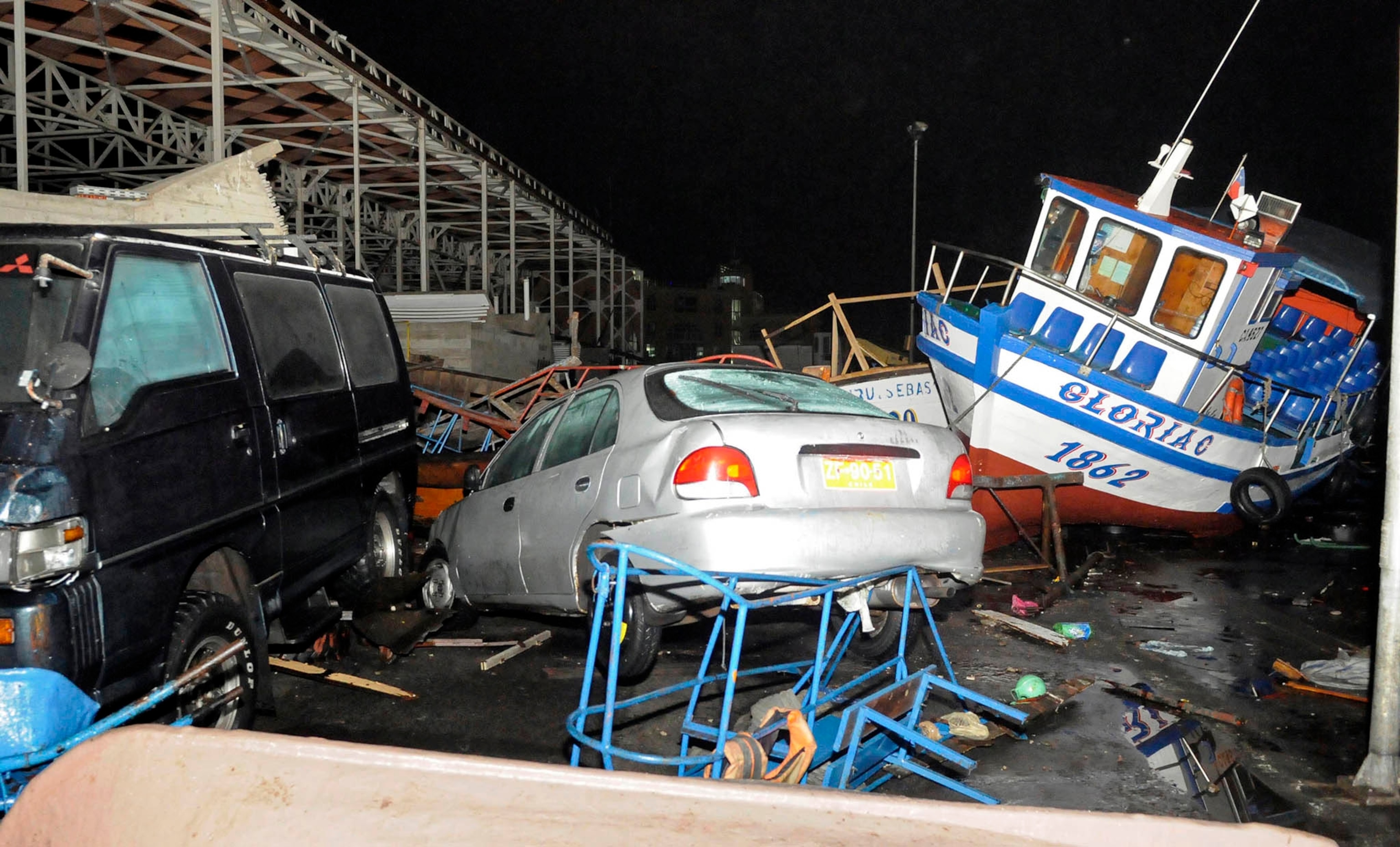 Vehicles and boats lie on the shore after a tsunami hit the northern port of Iquique, April 2, 2014. A major earthquake of 8.2 magnitude struck off the coast of northern Chile on Tuesday, causing five deaths and triggering the tsunami that pounded the shore with 2-meter-tall waves.