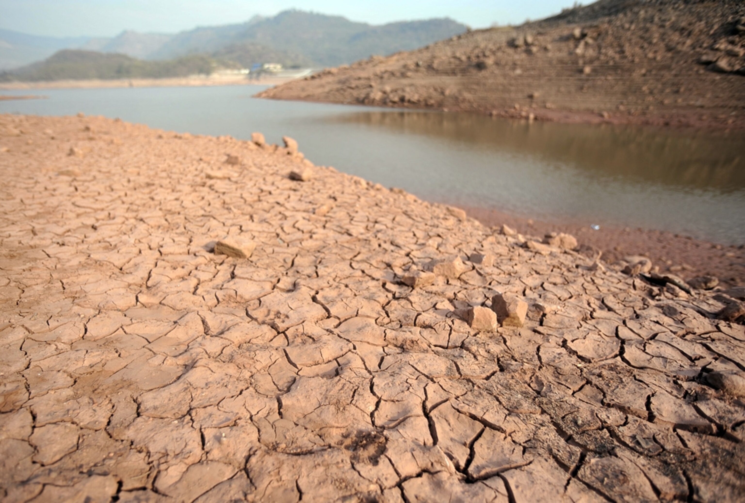 Cracked, parched mud of the dried-up lake bed at Simli Dam