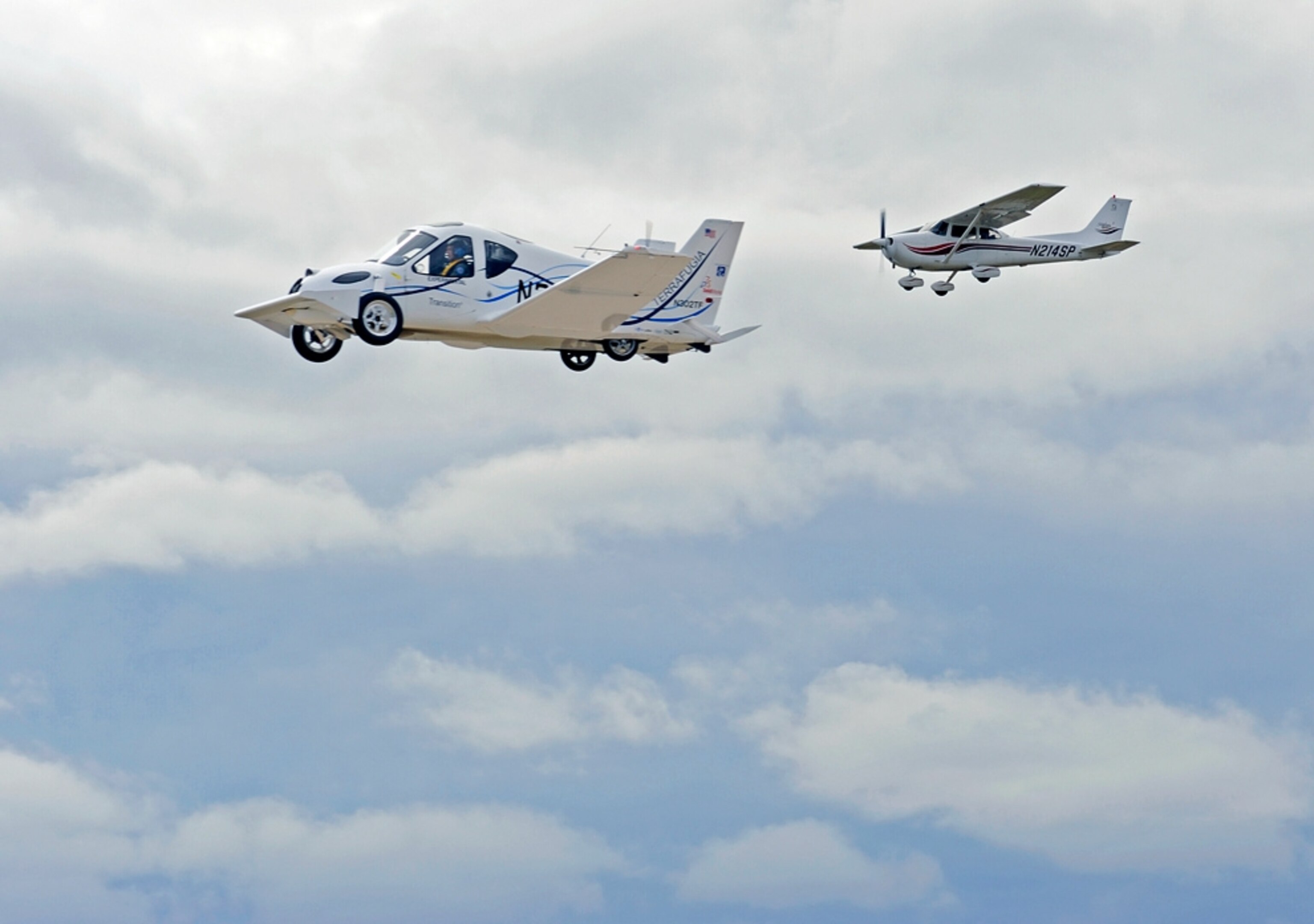a Transition flying car and chase plane in flight