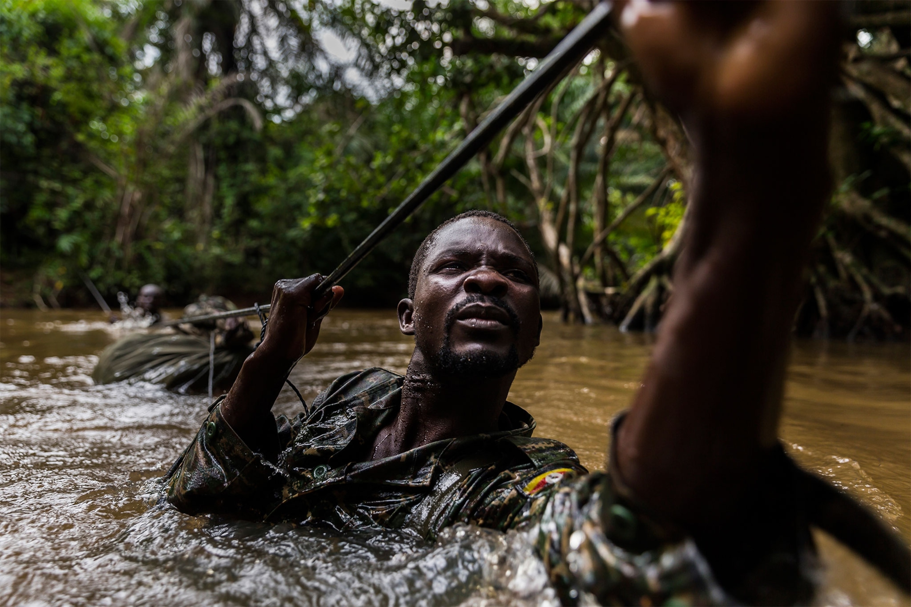 a Ugandan soldier crossing a river in Centrai African Republic