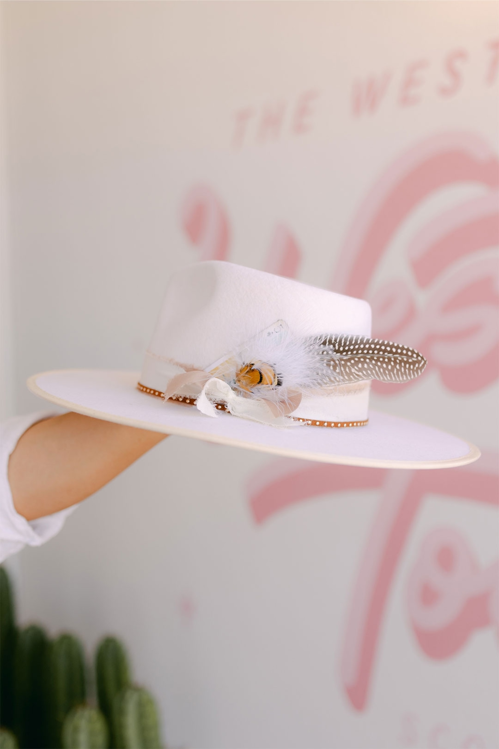 pastel pink cowboy hat with ribbons